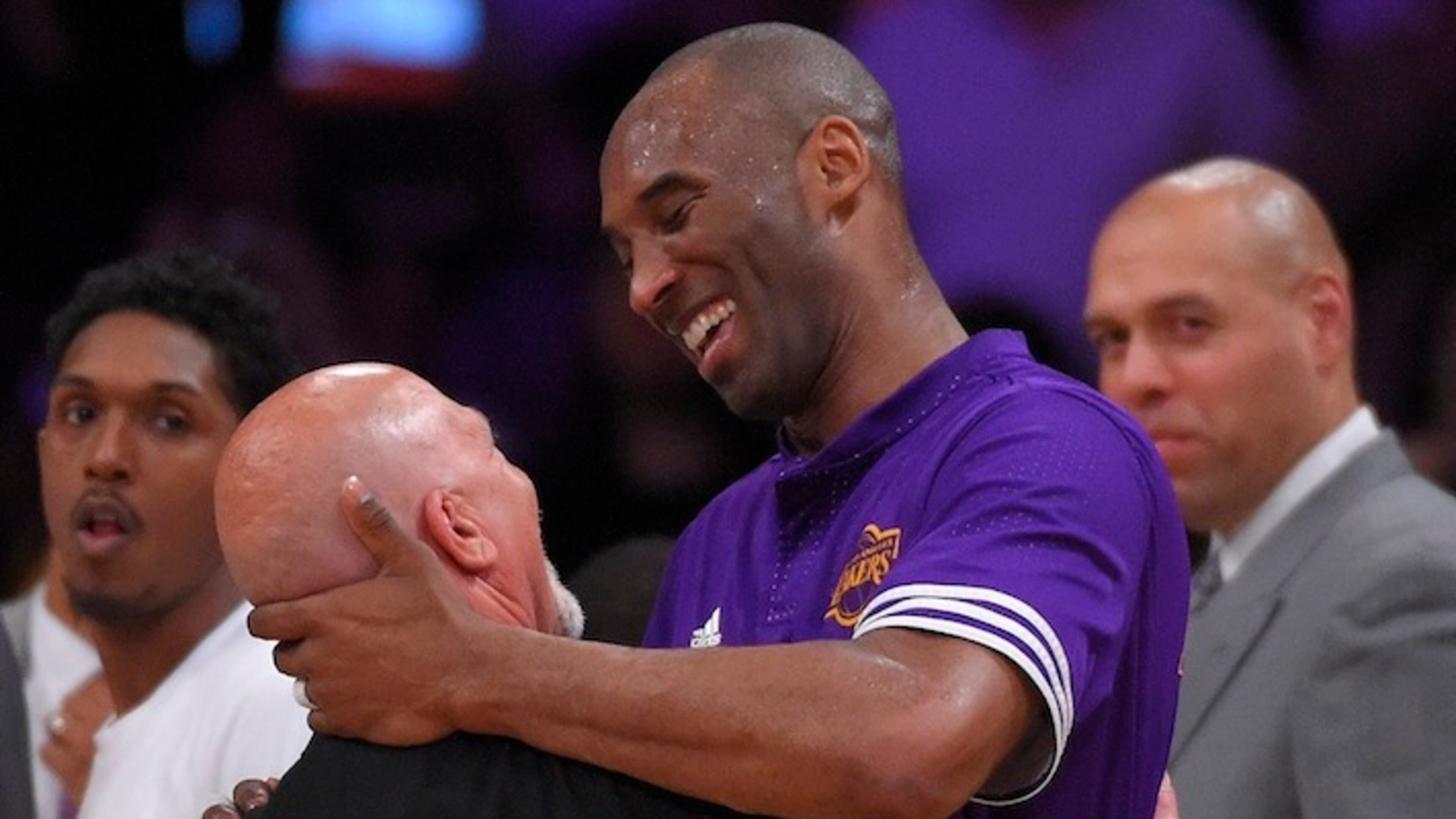 Los Angeles Lakers forward Kobe Bryant, right, hugs Lakers' trainer Gary Vitti after Vitti was honored during a retirement ceremony during the first half of an NBA basketball game against the Boston Celtics, Sunday, April 3, 2016, in Los Angeles. (AP Photo/Mark J. Terrill)