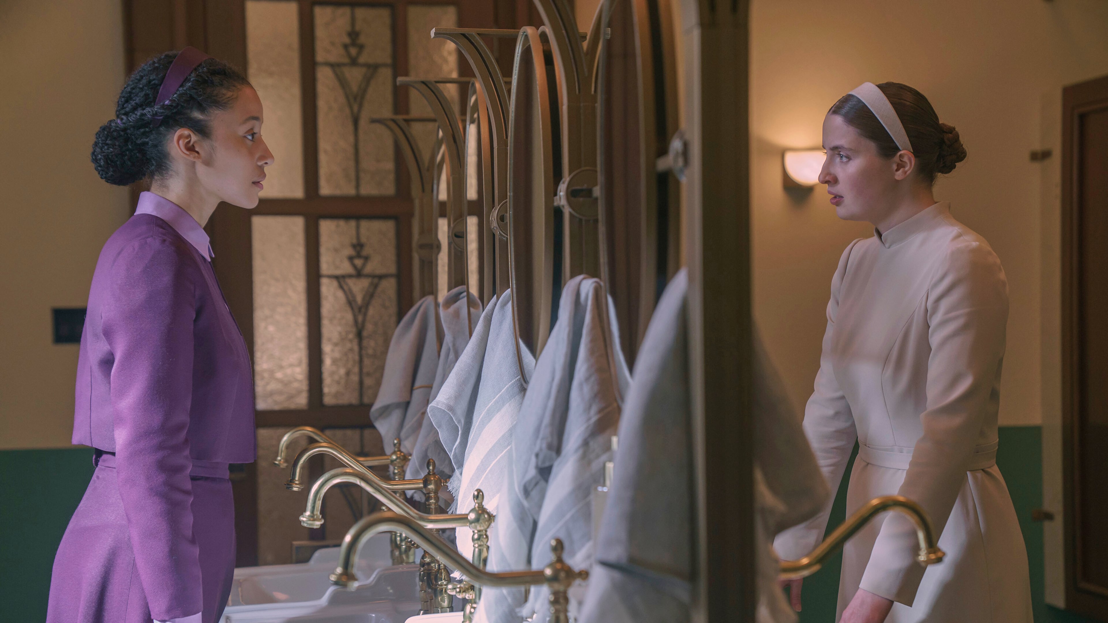 This image released by Disney shows Chase Infiniti, left, and Lucy Halliday in a scene from "The Testaments." (Steve Wilkie/Disney via AP)