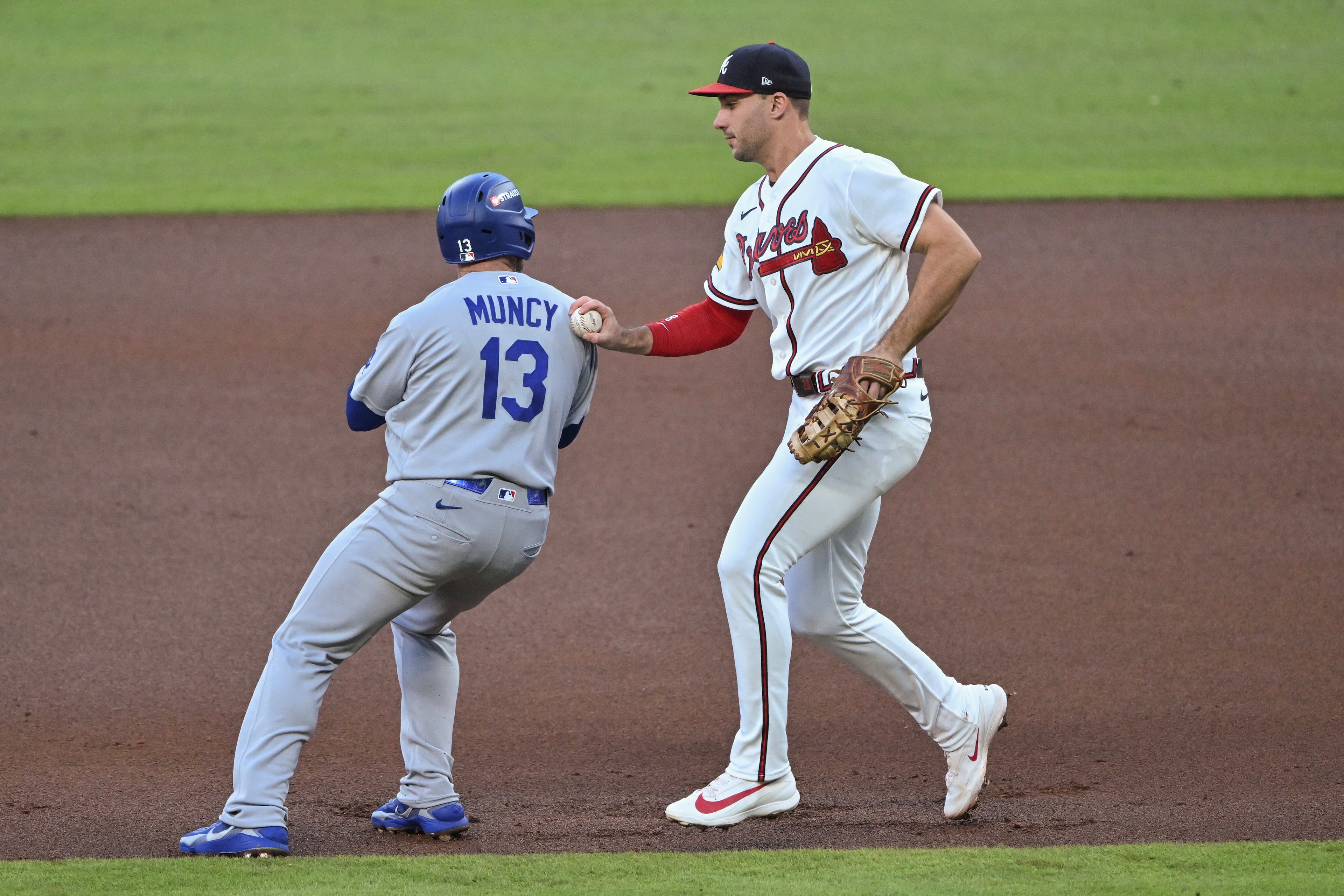 Atlanta Braves first baseman Matt Olson (28) tags out Los Angeles Dodgers' Max Muncy (13) to complete a double play during the second inning of Game 4 of the MLB National League Division Series between the Atlanta Braves and the Los Angeles Dodgers, Wednesday, Oct. 7, 2026, in Atlanta. (Hyosub Shin/AJC)
