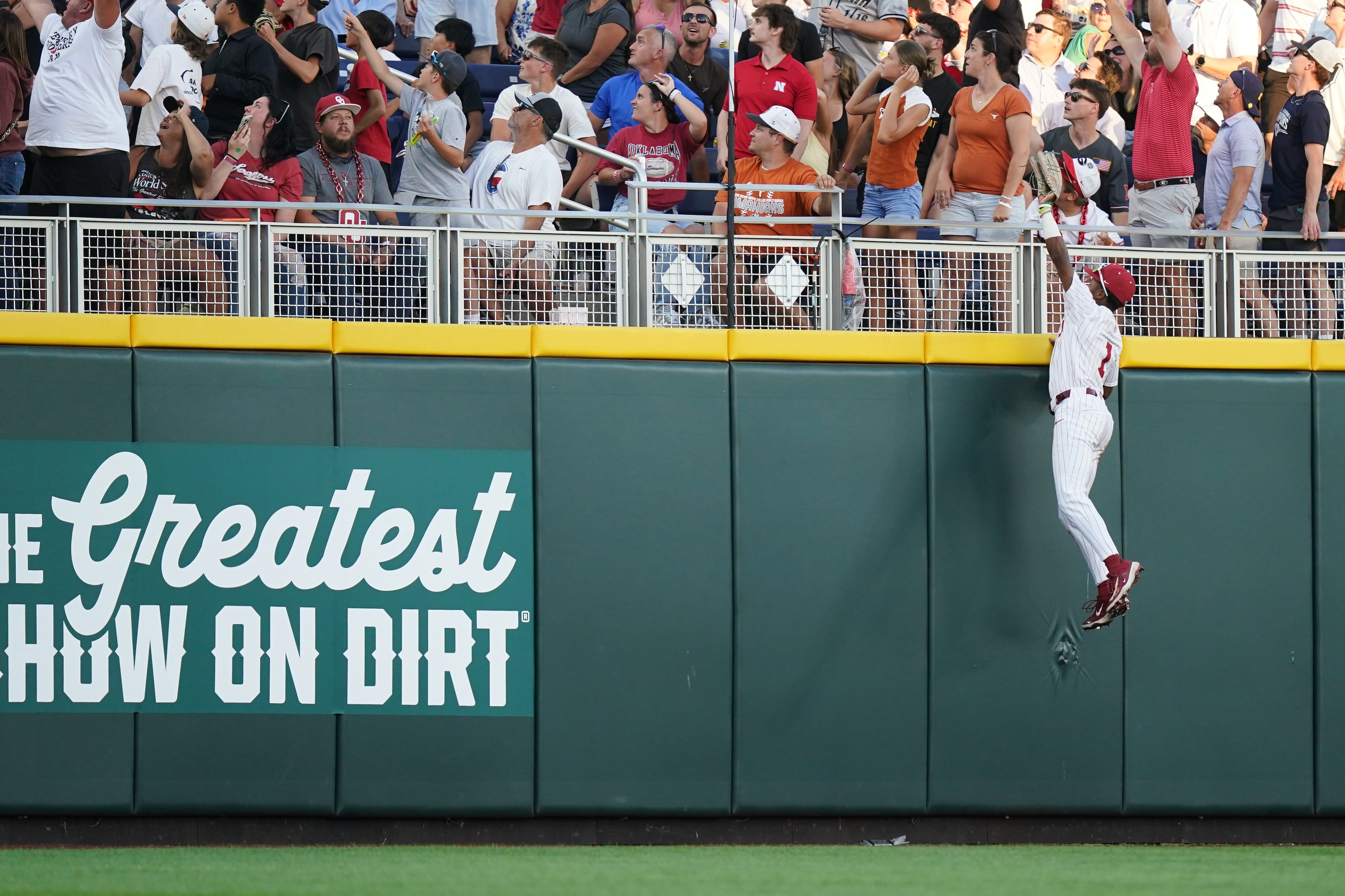 Oklahoma outfielder Jason Walk leaps in the air as the ball goes over the fence for a home run during a College World Series game against Georgia on Monday, June 15, 2026, in Omaha, Neb. (Vera Nieuwenhuis/AP)