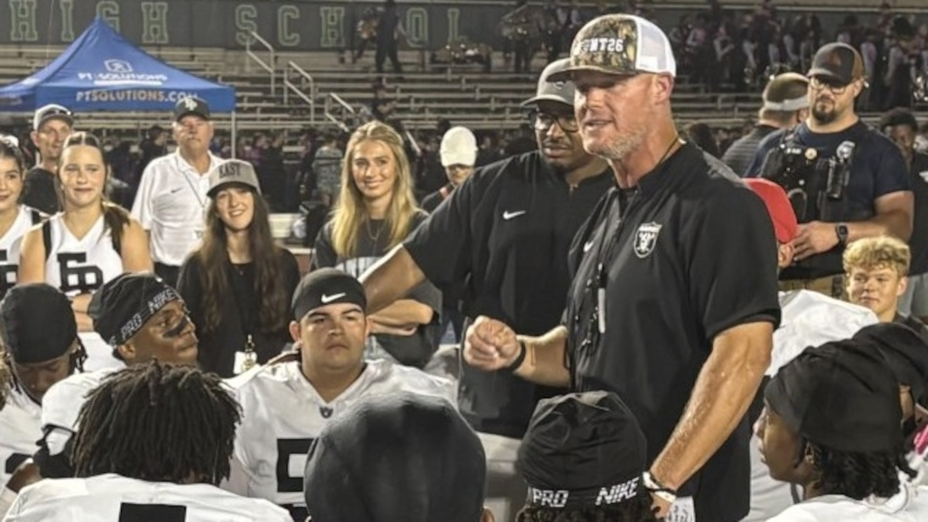 East Paulding coach Van Spence talks to his players after the Raiders' 27-23 victory over Harrison at Cobleigh Stadium on Aug. 28, 2026. (Chip Saye/AJC)