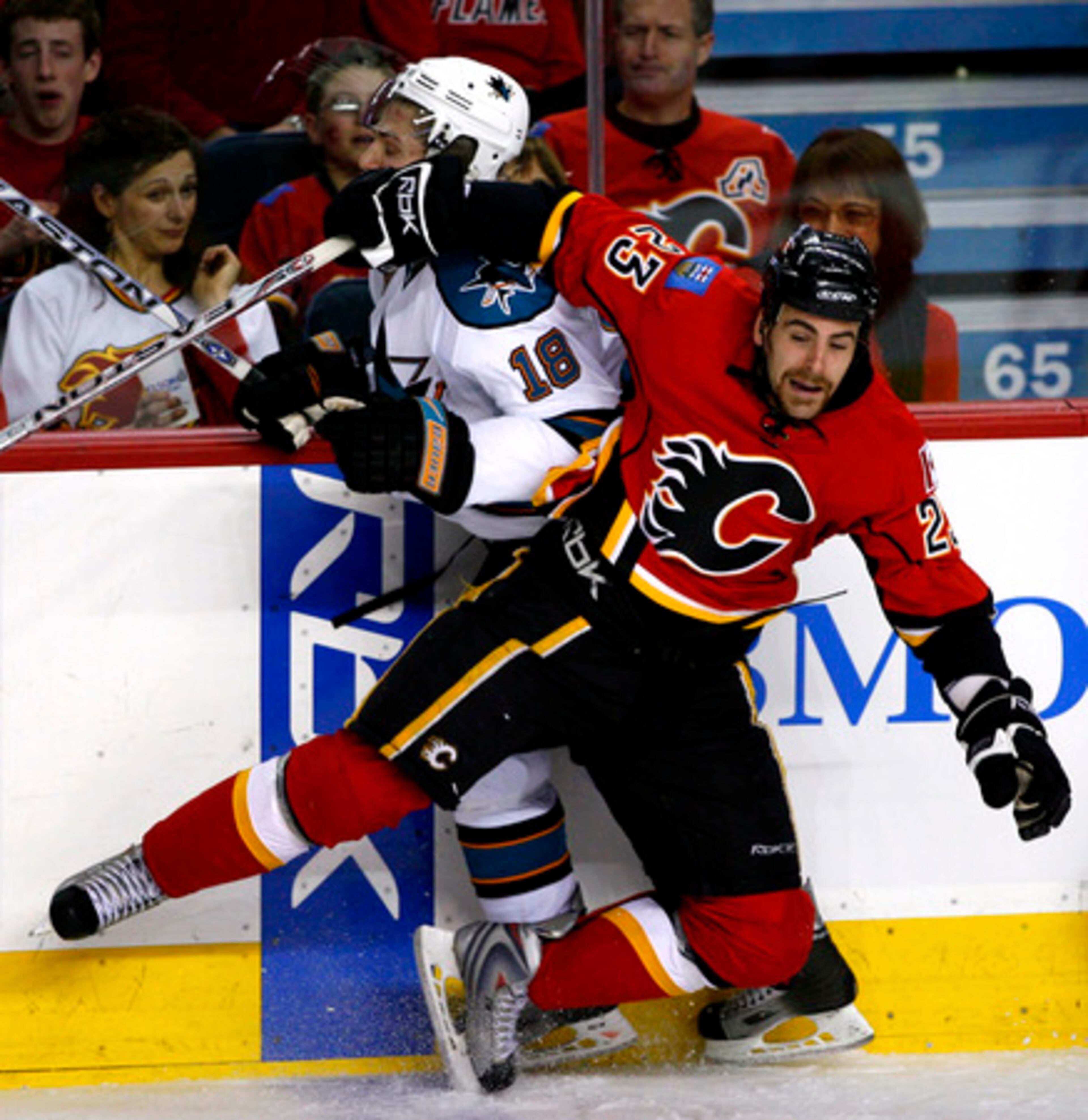 Flames' Eric Nystrom (right) is hit by San Jose Sharks' Matt Carle in game six of their NHL playoff in Calgary, Canada, on Sunday.