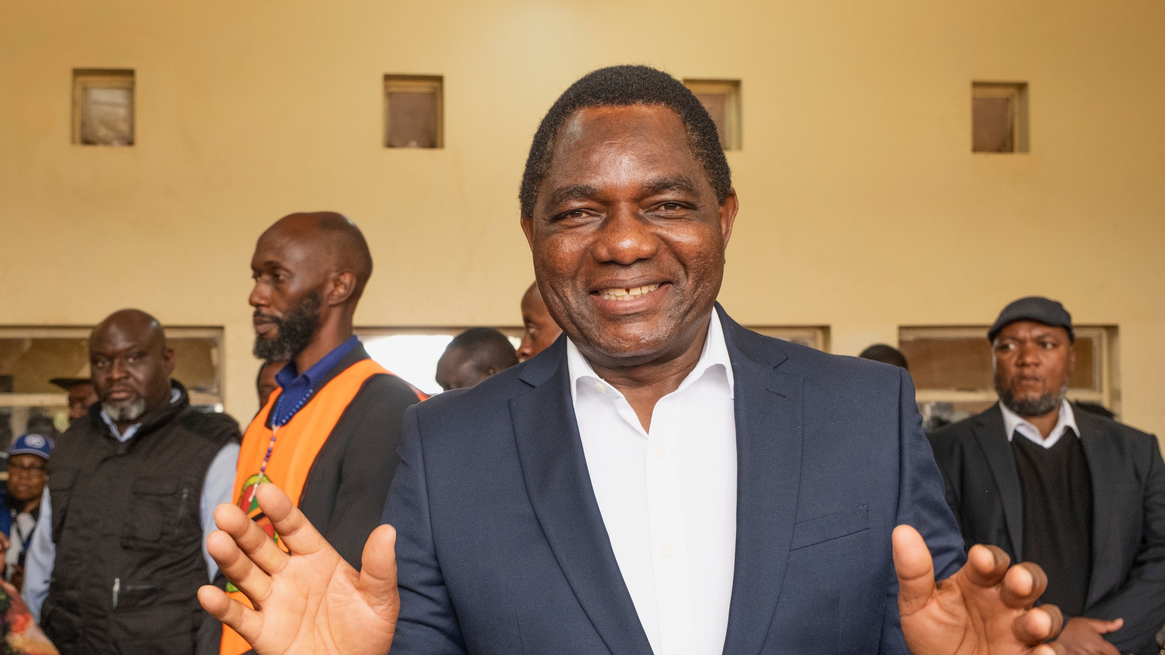 Zambia's President Hakainde Hichilema shares a light moment with journalists after casting his vote at a polling station in Lusaka, Zambia, Thursday, Aug. 13, 2026. (AP Photo/Anita Reed)