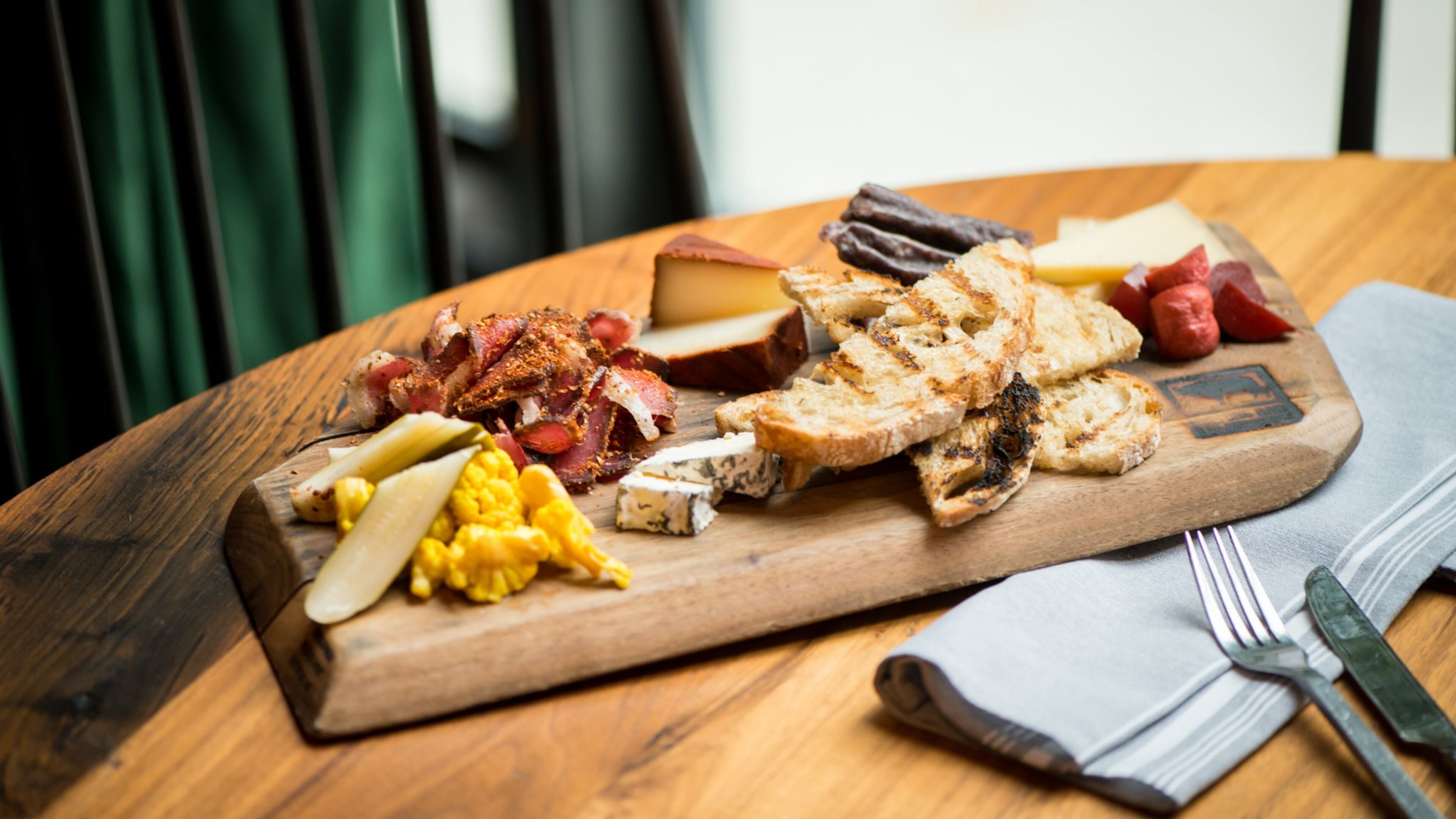 Biltong Bar Buckhead Biltong and Cheese plate with traditional, droewors, out of the ashes, griffin, alisios, house pickles, apricot chutney and grilled sourdough. Photo credit -Mia Yakel.