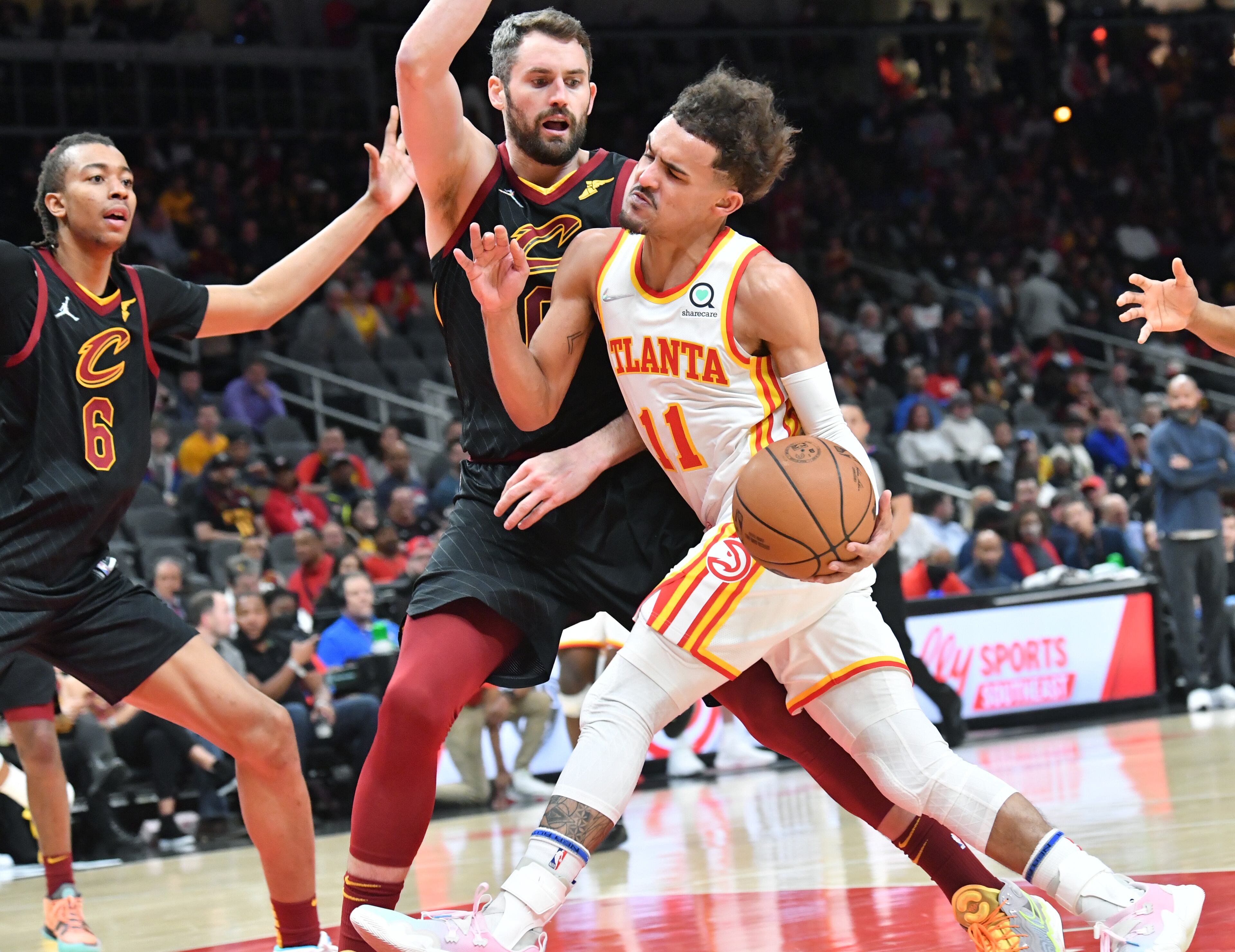 Hawks' guard Trae Young (11) drives against Cleveland Cavaliers' forward Kevin Love (0) during the first half in an NBA basketball game at State Farm Arena on Thursday, March 31, 2022. Atlanta Hawks won 131-107 over Cleveland Cavaliers. (Hyosub Shin / Hyosub.Shin@ajc.com)