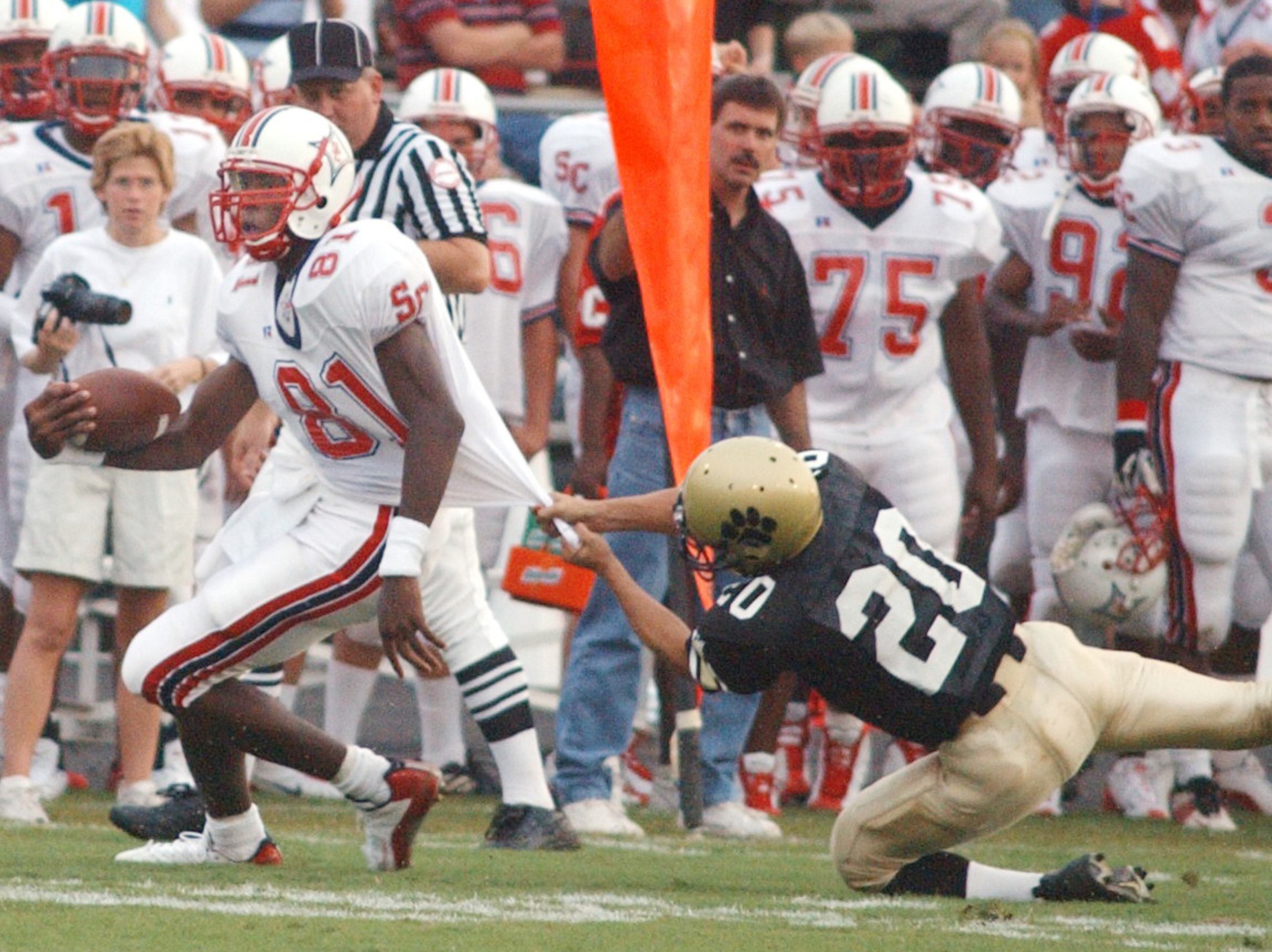Sandy Creek receiver Calvin Johnson (81) gets away from Fayette County High's Jamil Merchant for a first down during a game Friday, Sept. 5, 2003, in Fayetteville. (Marlene Karas/AJC)