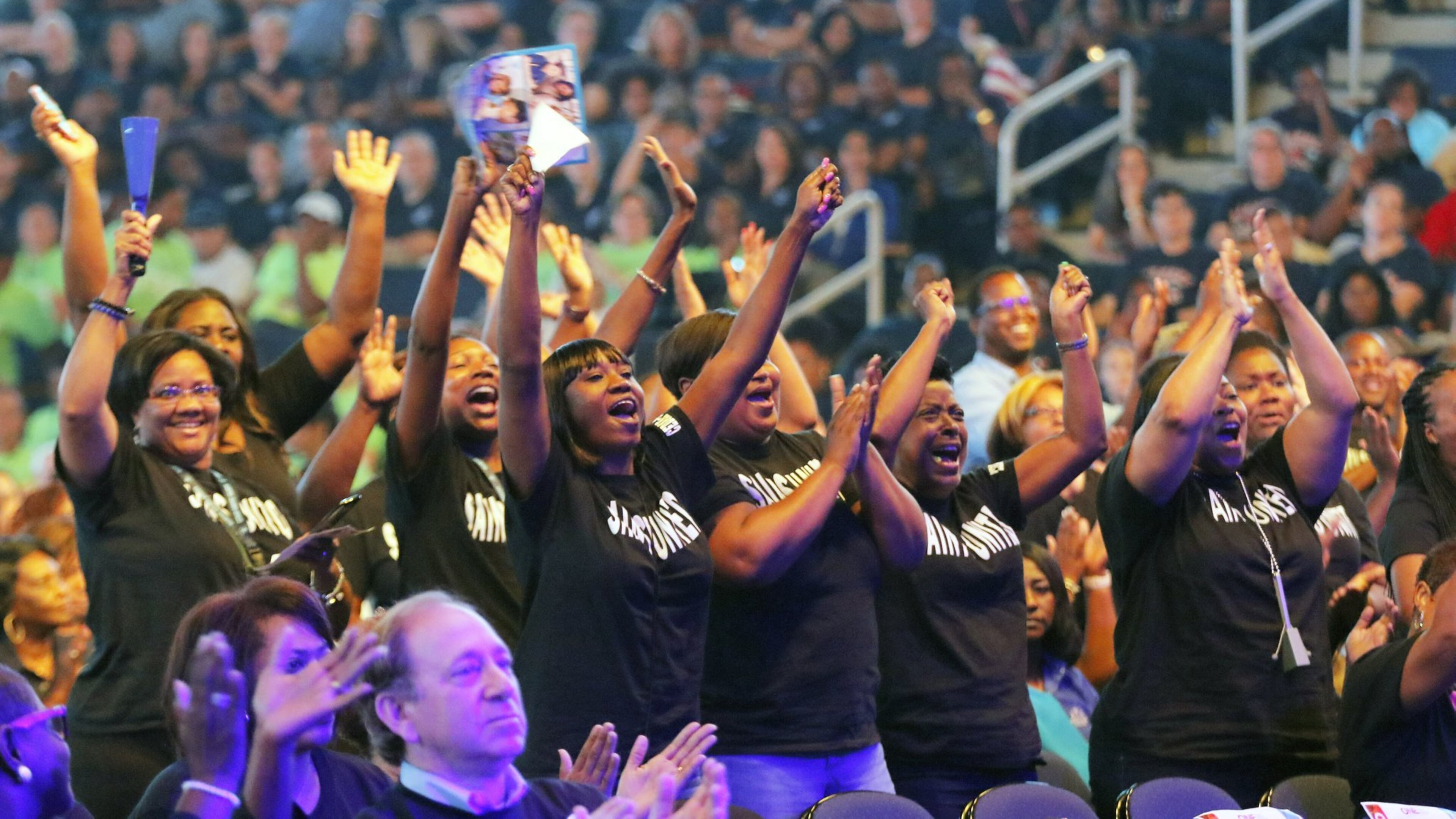 DeKalb County School District teachers and staff cheer performers at a back-to-school convocation in August in Duluth. BOB ANDRES /BANDRES@AJC.COM