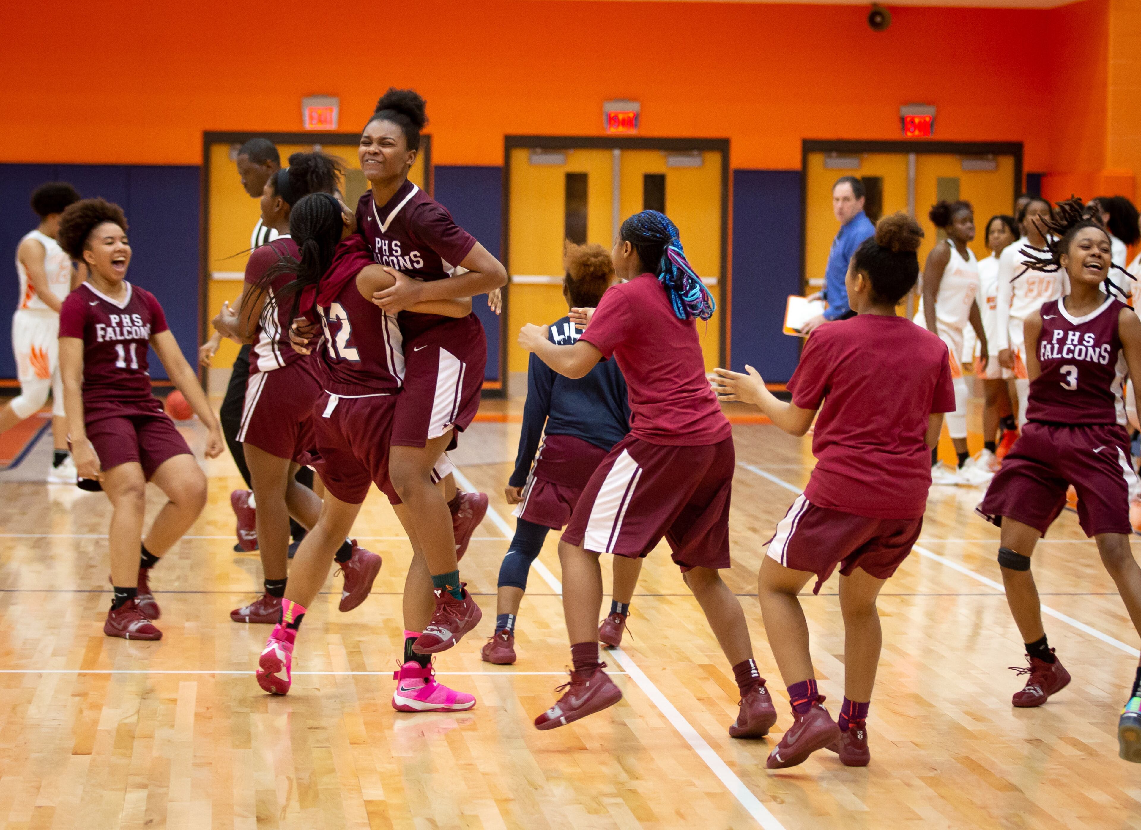 Pebblebrook High School basketball players celebrate after beating North Cobb High School in the first round of the girls' high school basketball tournament in Kennesaw February 15, 2019. STEVE SCHAEFER / SPECIAL TO THE AJC