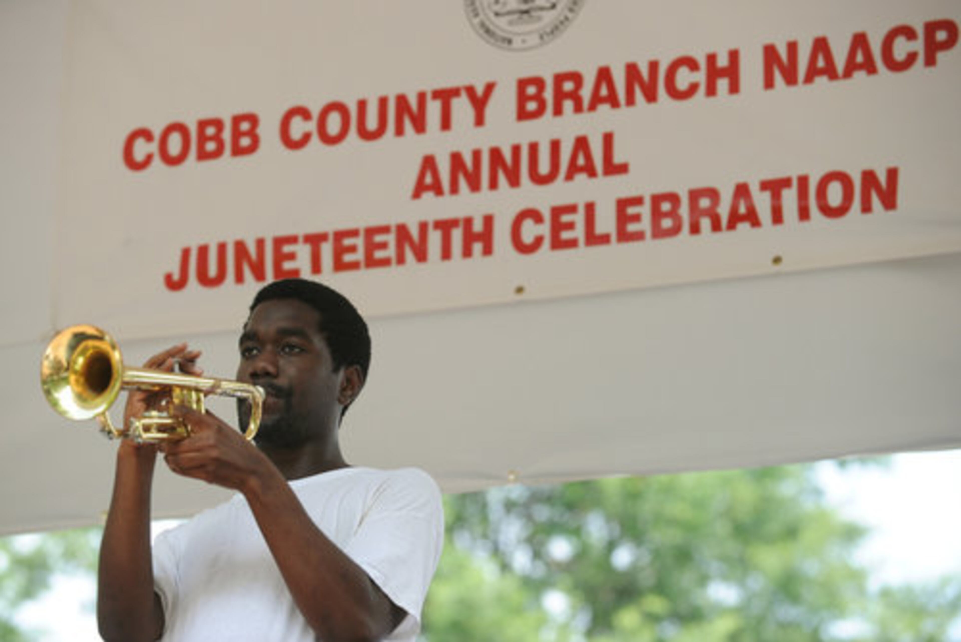 Henry Cooper Jr. plays his trumpet on the stage during the Cobb County branch of the NAACP 8th Annual Marietta Juneteenth Celebration on historic Marietta Square on Saturday, June 18, 2011.