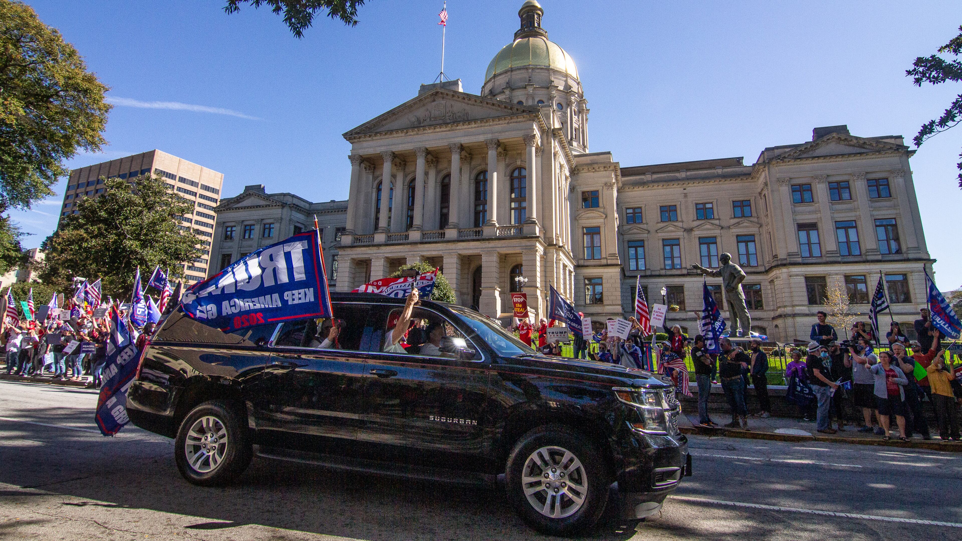 Cars and trucks with signs in support of President Donald Trump circle the state Capitol in Atlanta on Saturday, November 14, 2020. (Photo: Steve Schaefer for The Atlanta Journal-Constitution)