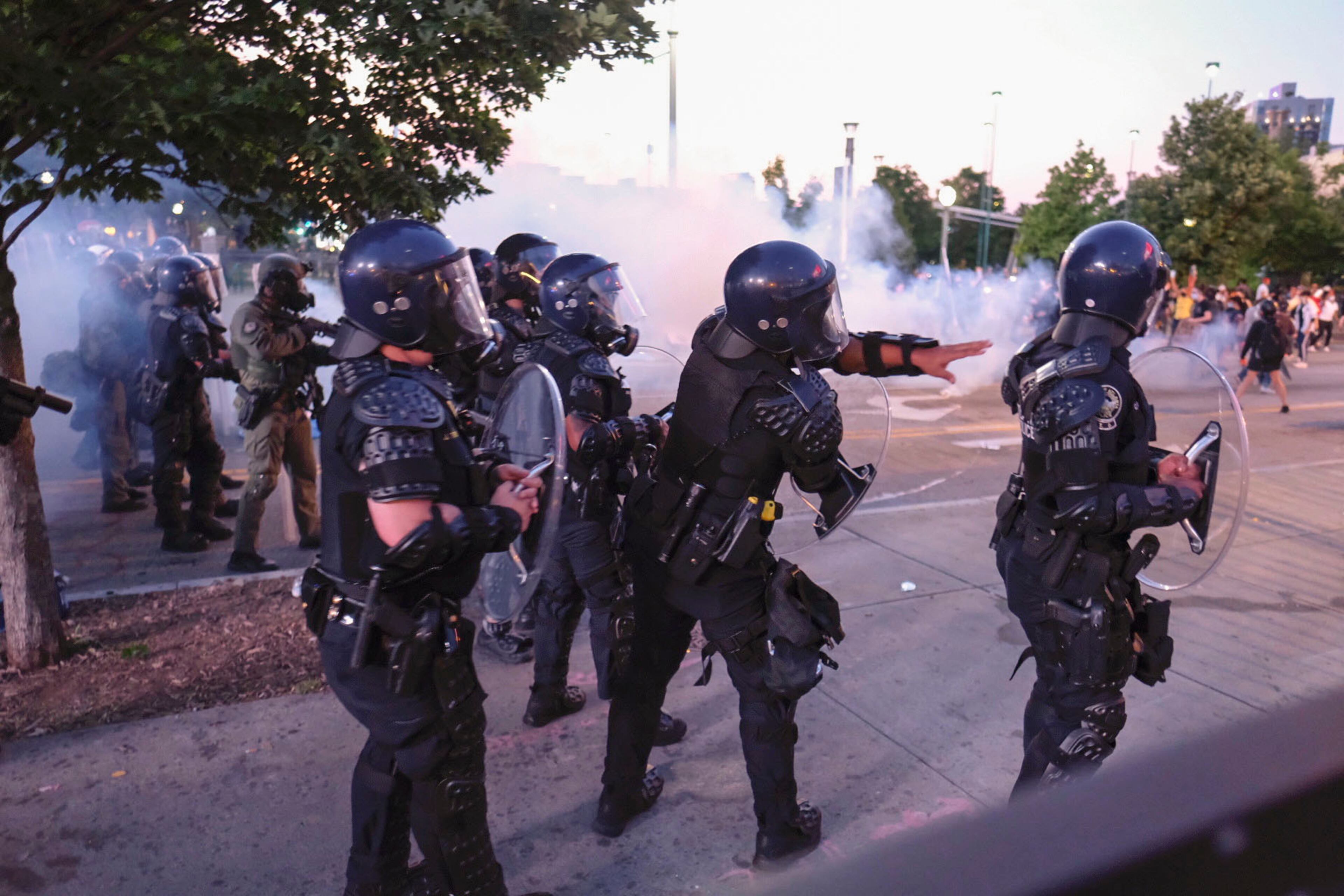 June 2, 2020 - Atlanta - Protestors dodge tear gas and police after the 9pm curfew in downtown Atlanta as protests continued for a fourth day. Protests over the death of George Floyd in Minneapolis police custody continued around the United States, as his case renewed anger about others involving African Americans, police and race relations. Ben Gray for the Atlanta Journal Constitution