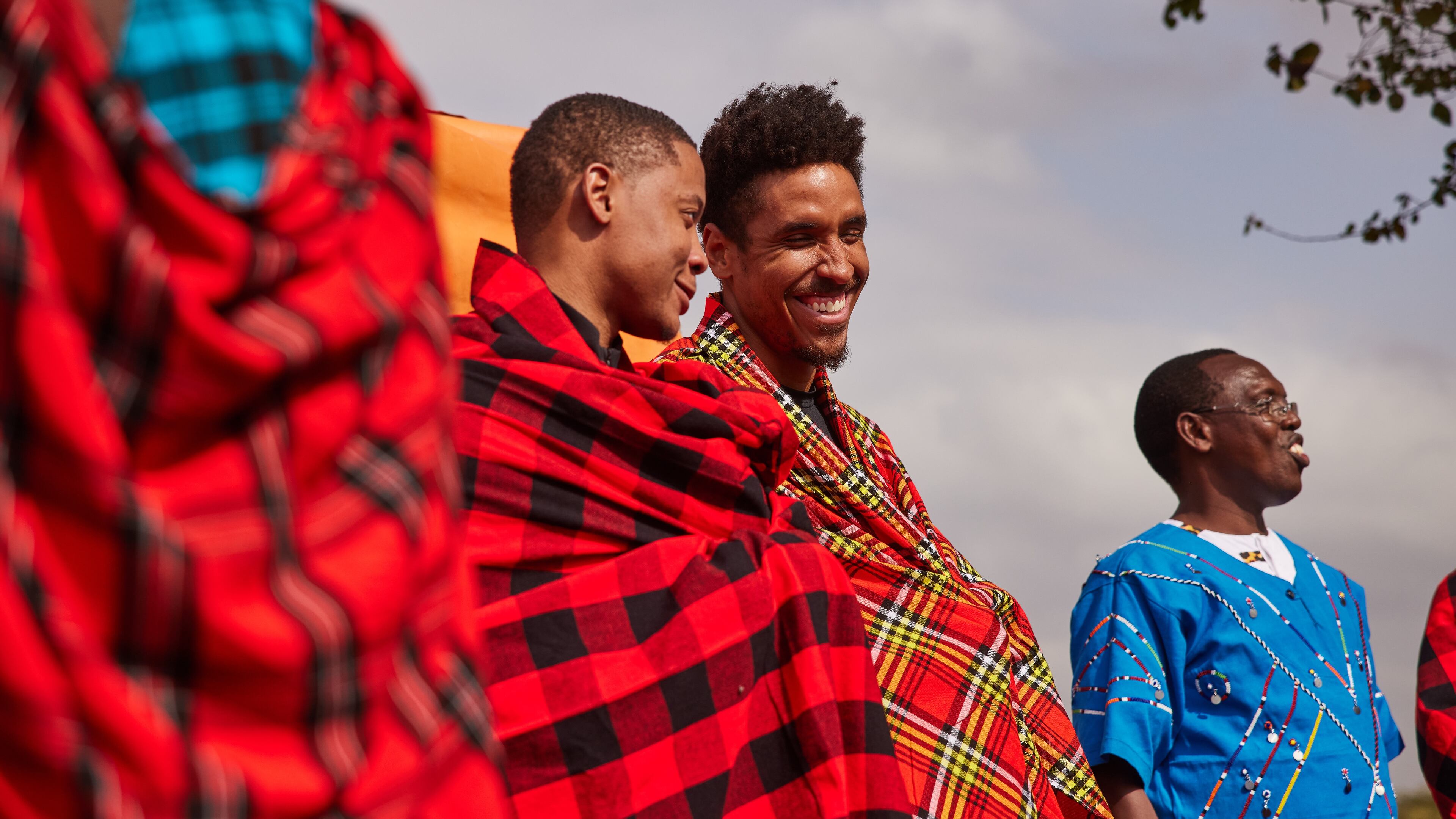 Malcolm Brogdon and his family foundation recently made a trip to Tanzania and Kenya. Brogdon (center) and NBA player Tim Frazier join in a celebration.