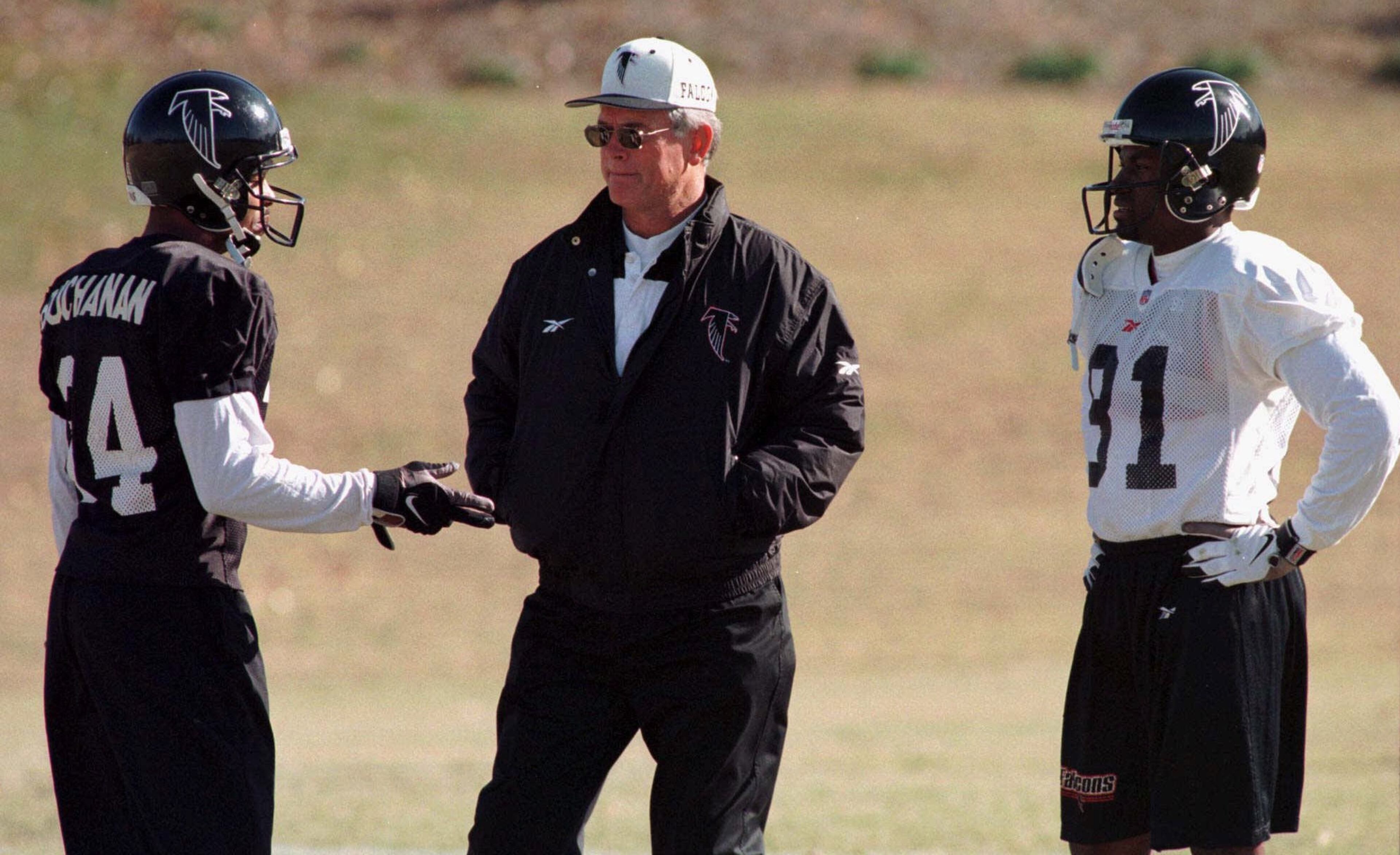 Atlanta Falcons head coach Dan Reeves, center, talks with cornerback Ray Buchanan, left, and Terance Mathis, right, during the team's practice in Suwanee, Ga. on Wednesday, Nov. 11, 1998. The Falcons face the San Francisco 49'ers on Sunday for first place in the NFC West. (AP Photo/Alan Mothner)