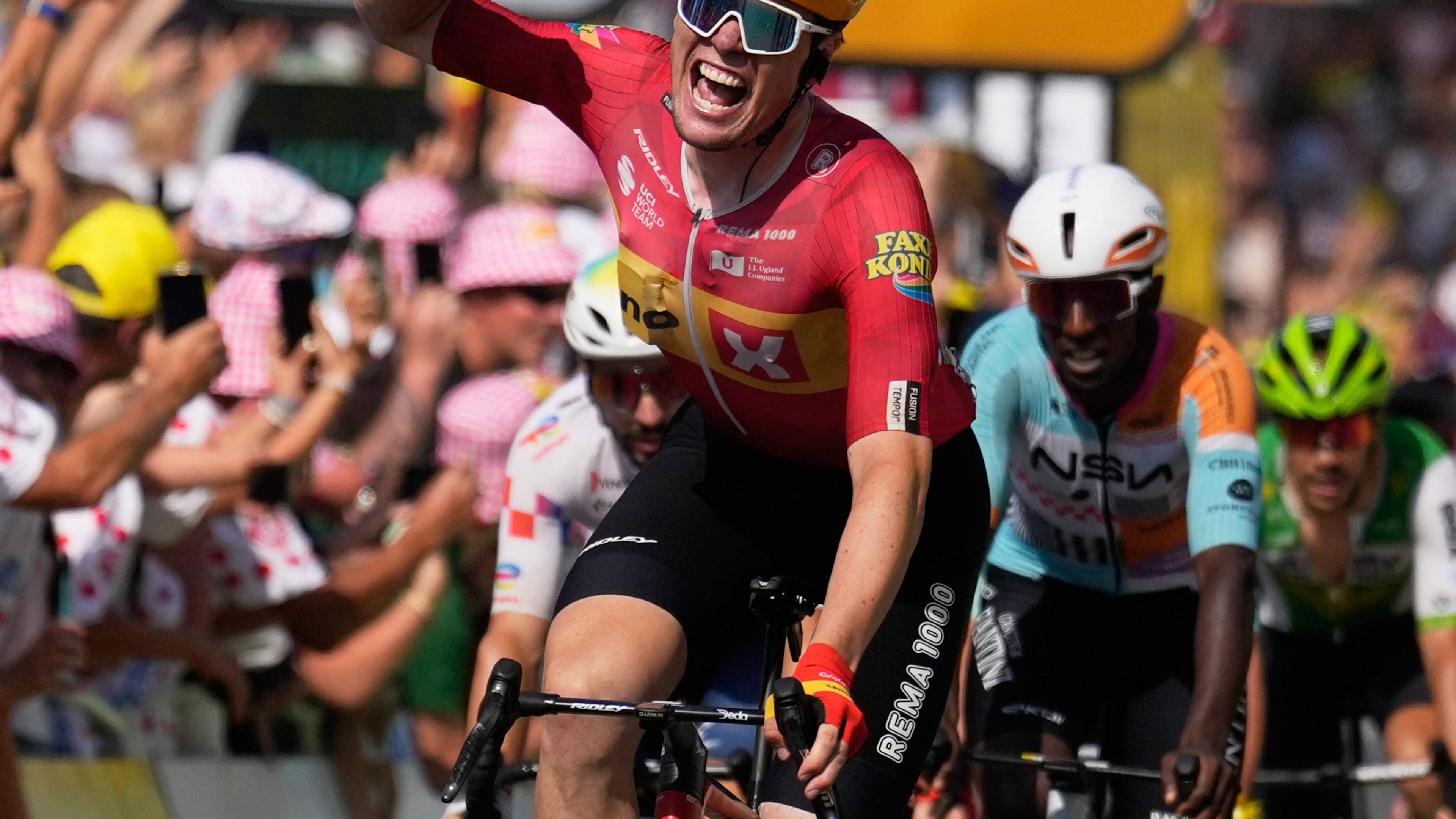Norway's Soren Waerenskjold celebrates as he crosses the finish line to win the eleventh stage of the Tour de France cycling race with start in Vichy and finish in Nevers, France, Wednesday, July 15, 2026. (AP Photo/Mosa'ab Elshamy)