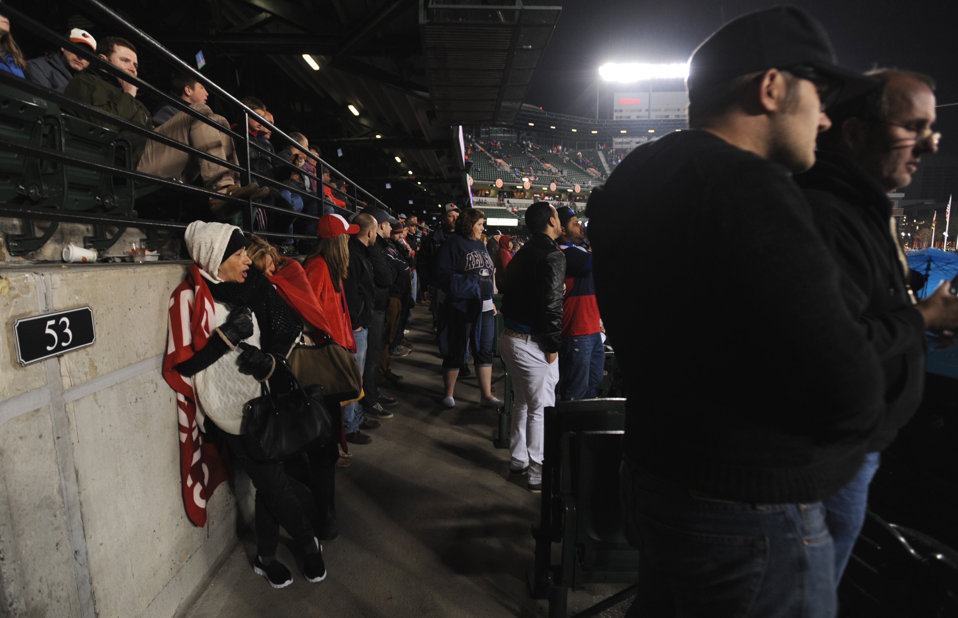 Fans fill the aisles in the ballpark after being told not to leave for their own safety during the Baltimore Orioles and the Boston Red Sox baseball game, Saturday, April 25, 2015, in Baltimore. The stadium was on lockdown after violence occurred after a march for Freddie Gray. Gray died April 19 after suffering a fatal spinal injury while in police custody. (AP Photo/Gail Burton)
