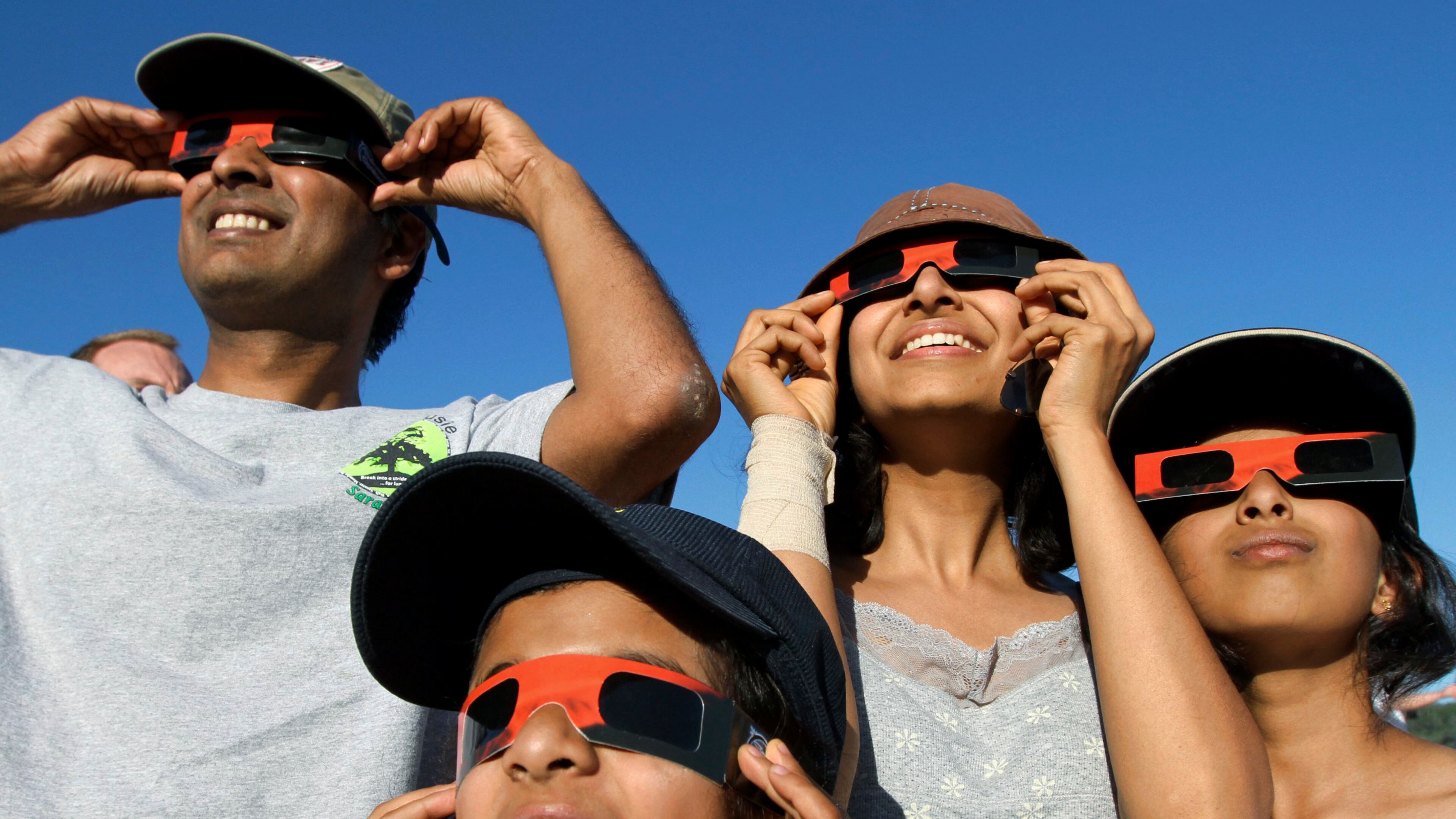 People observe the solar eclipse, Sunday, May 20, 2012 in Chico, Calif. The annular eclipse, in which the moon passes in front of the sun leaving only a golden ring around its edges, was visible to wide areas across China, Japan and elsewhere in the region before moving across the Pacific to be seen in parts of the western United States. (AP Photo/The Chico Enterprise-Record, Ty Barbou)