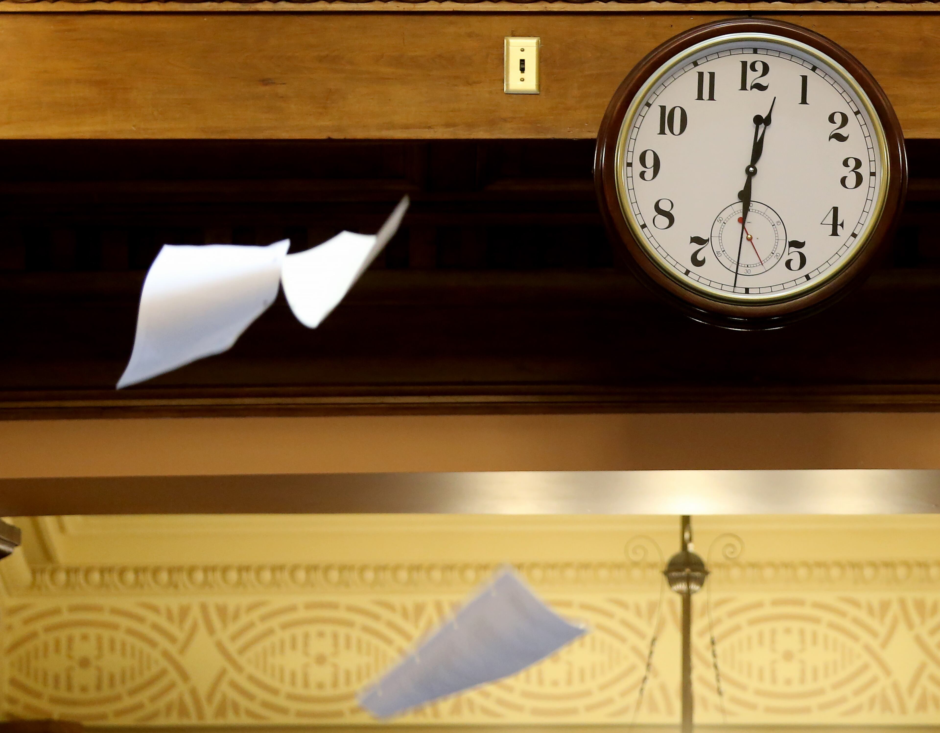 March 25, 2016 Atlanta: The clock in the House chamber shows just after 12:30 Friday morning March 25, 2016 as paper flies through the air at the end of the Legislative session. Ben Gray / bgray@ajc.com