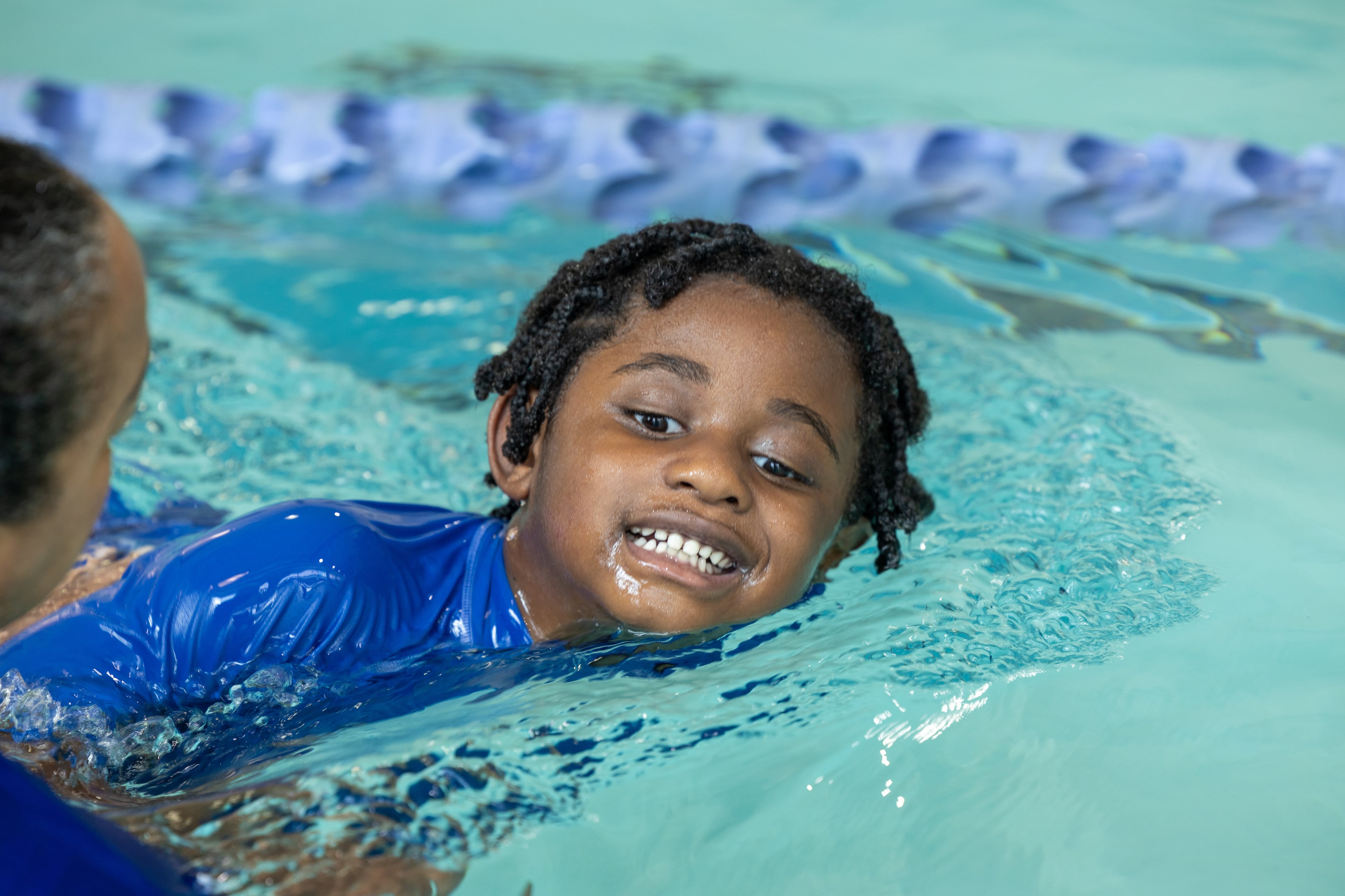 Lewis Davis, 4, participates in an adaptive swim program with his instructor, Lillian Thompson, at the Decatur YMCA earlier this month. (Phil Skinner for the AJC)