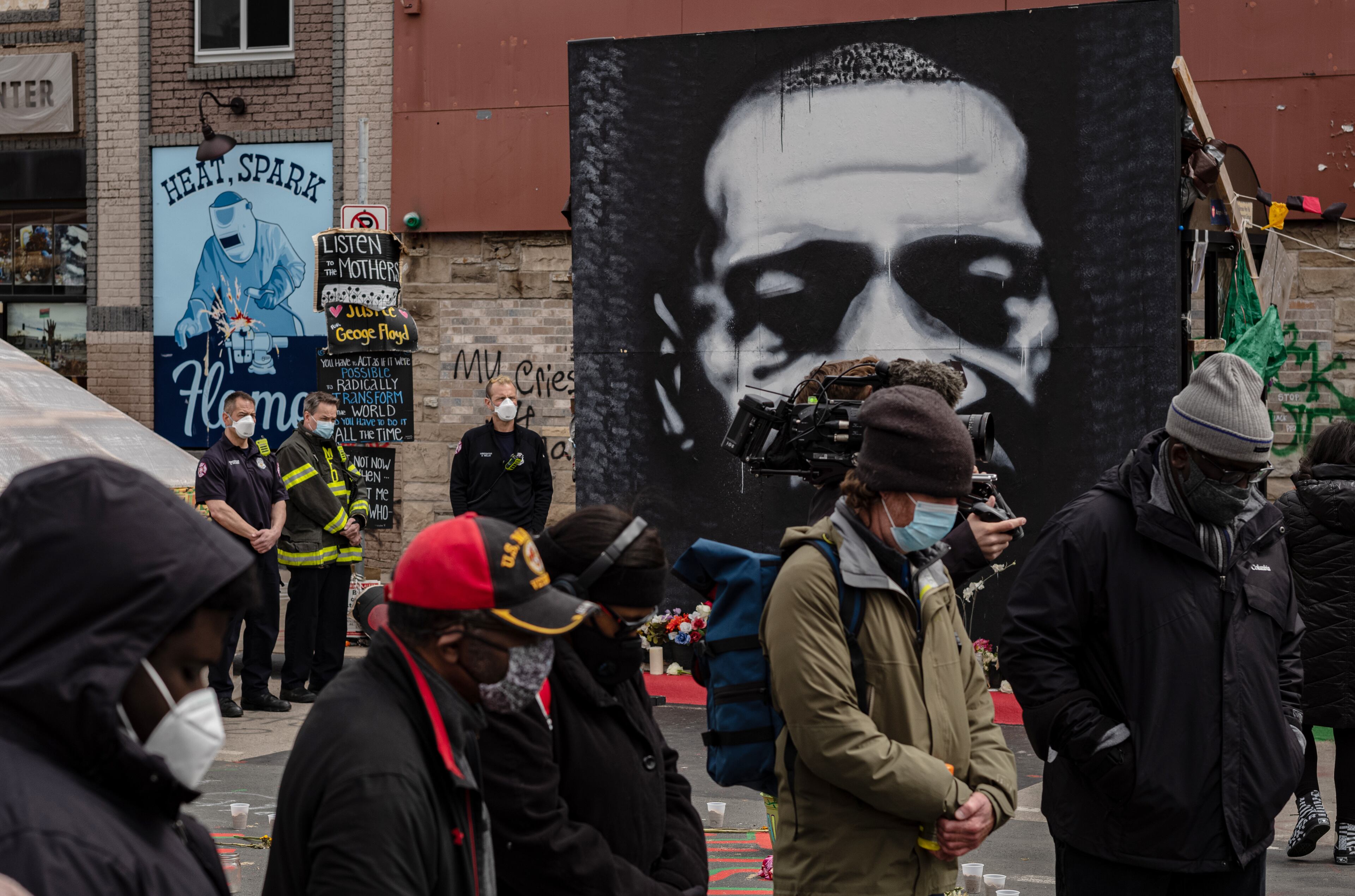 People pray near the George Floyd memorial in Minneapolis on Tuesday, April 20, 2021, as the jury prepares to deliver verdicts in the Derek Chauvin trial. Chauvin, a former police officer is charged in the death of George Floyd while in police custody last year. (Amr Alfiky/The New York Times)