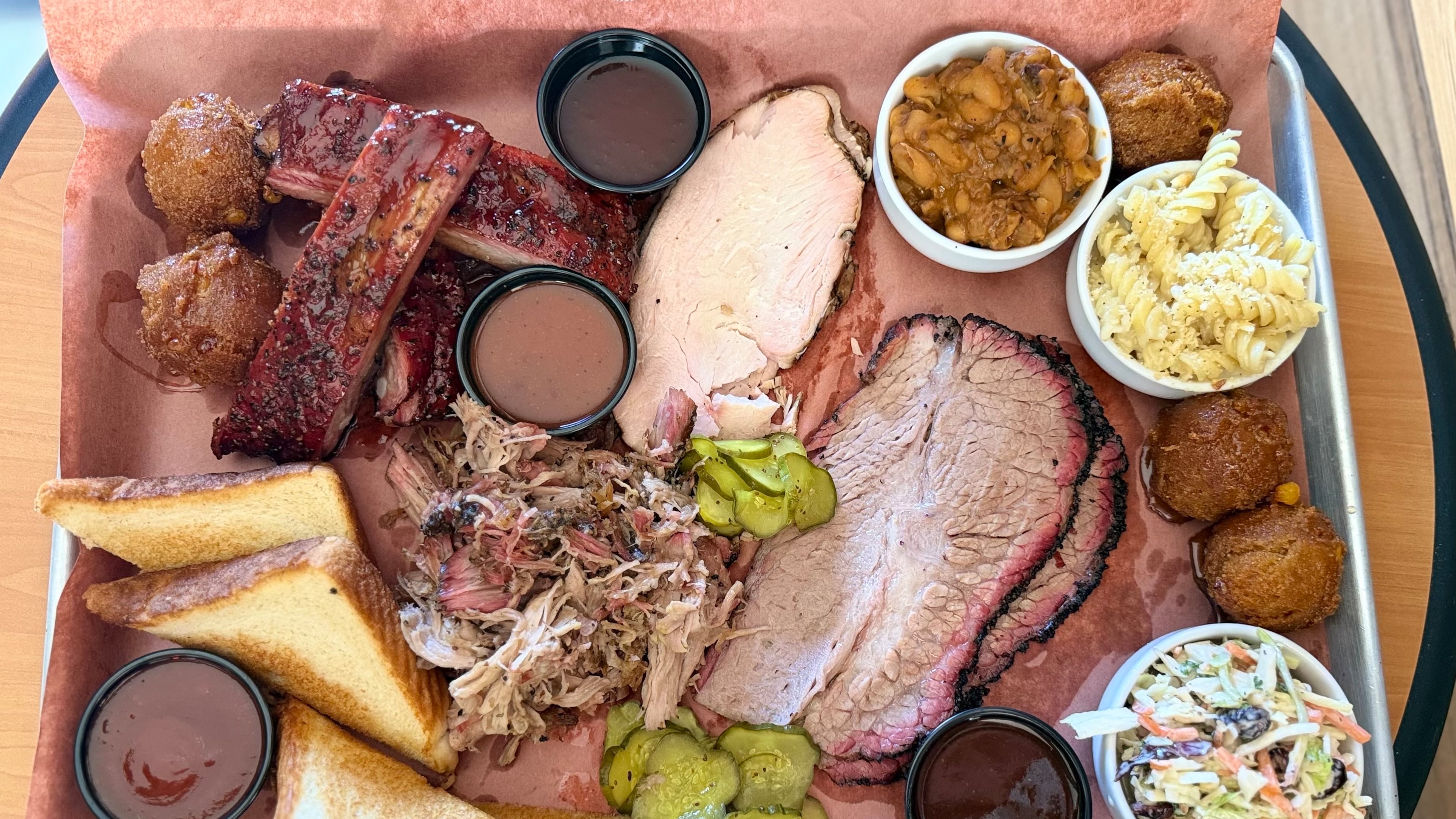 A barbecue platter is filled to the brim at Disruption BBQ in Henry County. (Justin Brown for the AJC)