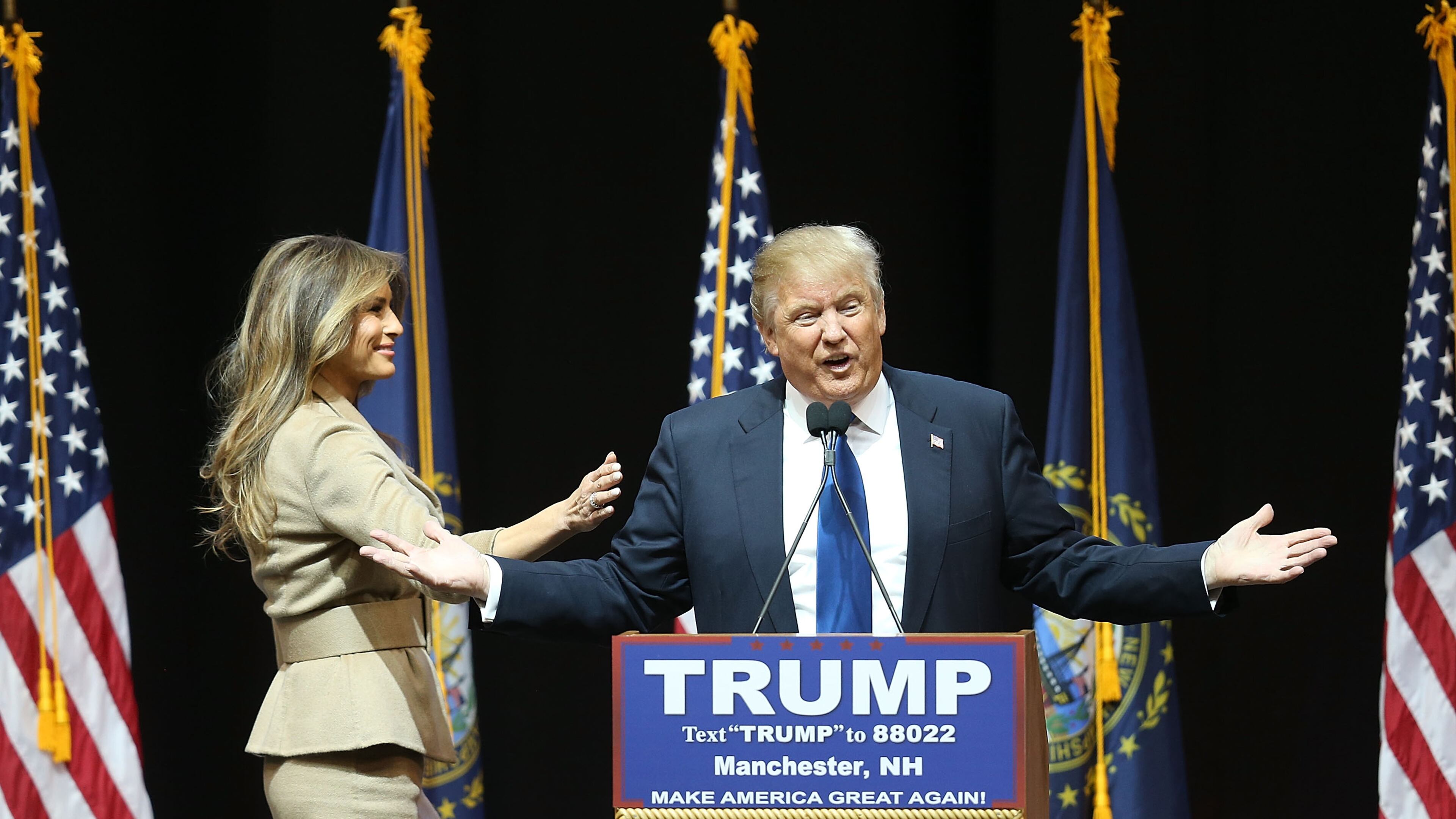 Republican presidential candidate Donald Trump speaks as his wife, Melania Trump, walks near during a Monday campaign rally in Manchester, N.H. Joe Raedle/Getty Images