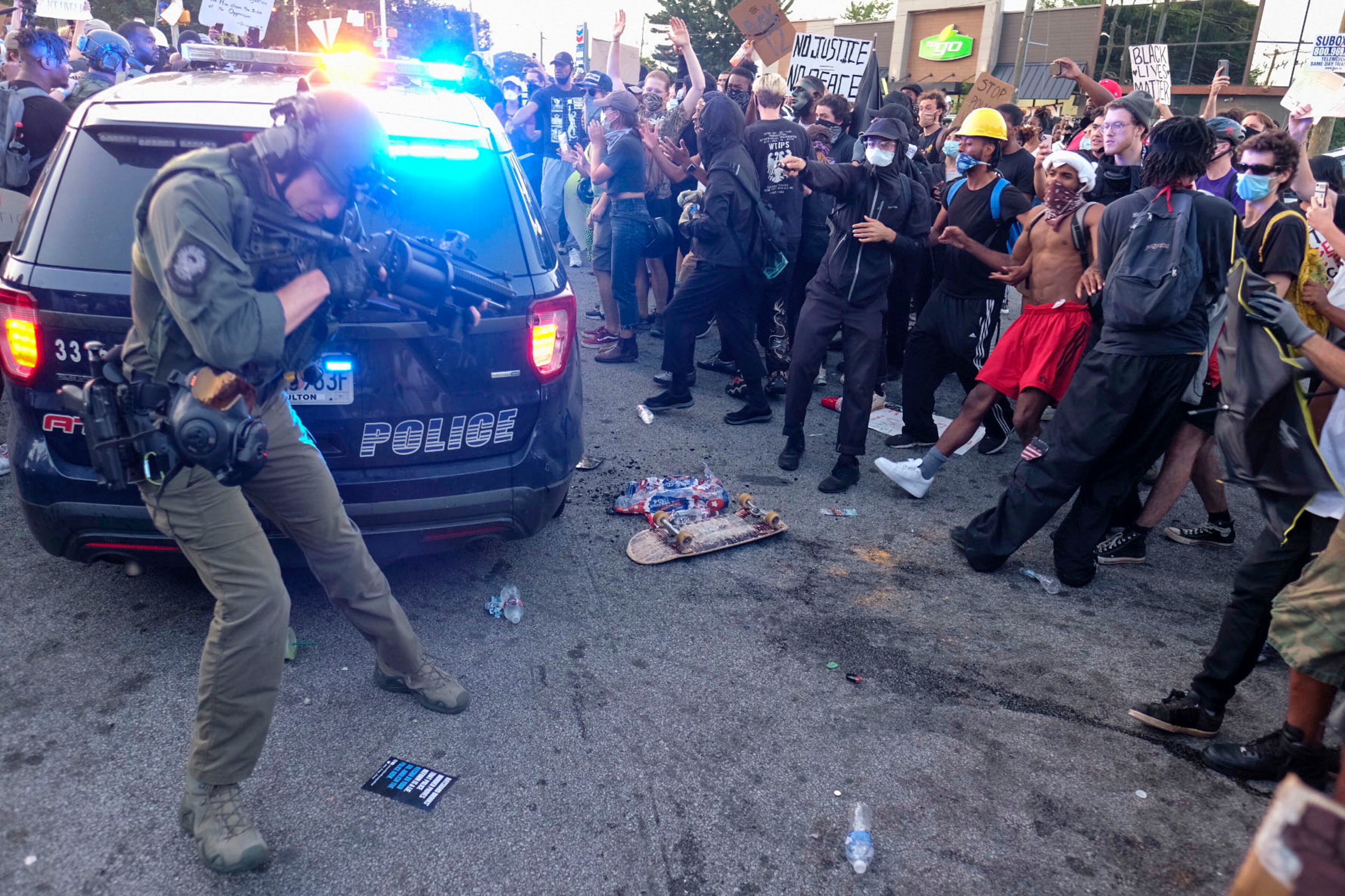 June 13, 2020 - Atlanta - Police deploy tear gas as the demonstration briefly got out of control. Protestors gather at University Ave. at the Atlanta Wendy's where Rayshard Brooks, a 27-year-old Black man, was shot and killed by Atlanta police Friday evening during a struggle in a Wendy's drive-thru line. Ben Gray for the Atlanta Journal Constitution