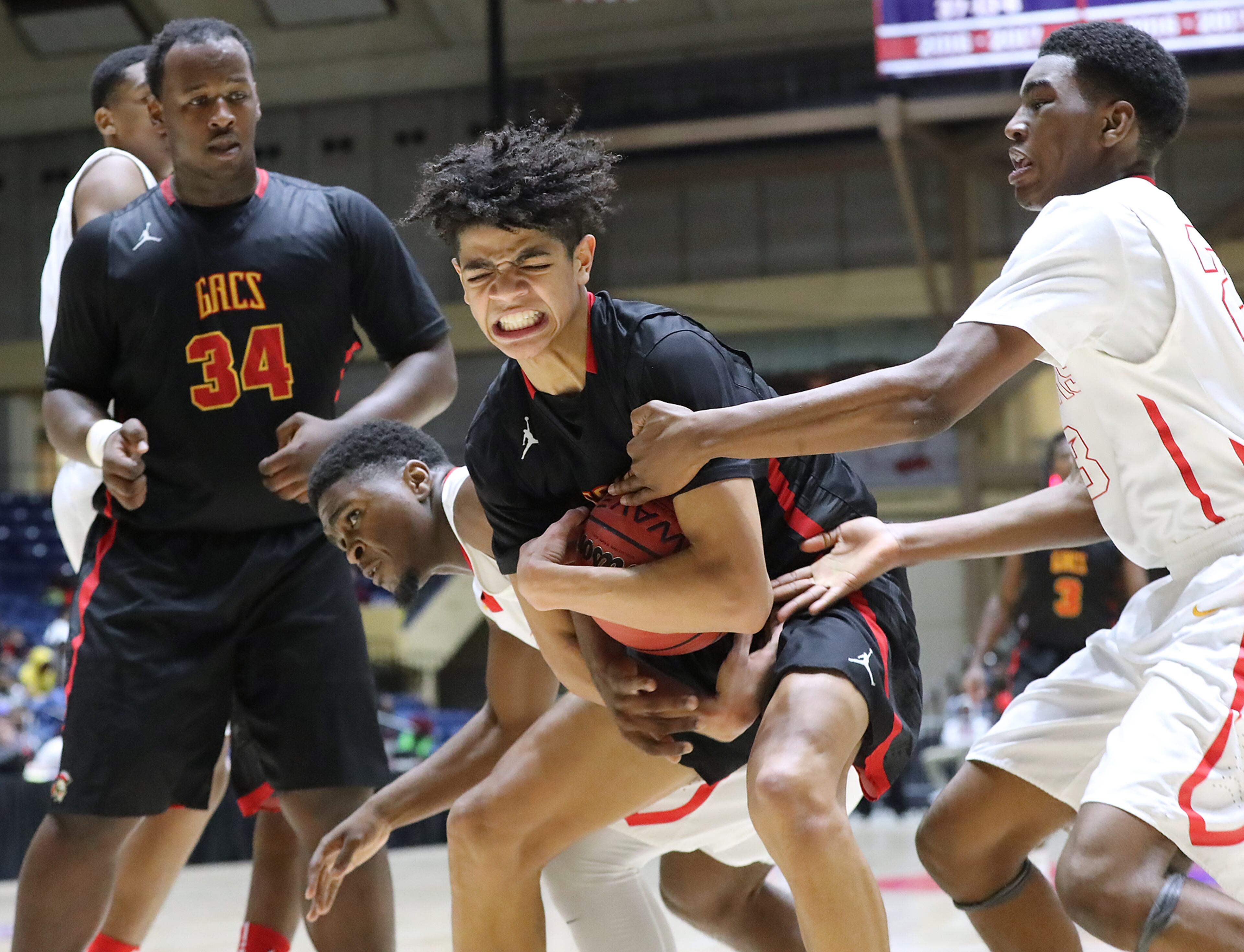 March 8, 2018 Macon: GAC guard Ben Sheppard wins the rebound battle against Jenkins defenders in their GHSA state basketball championship game on Thursday, March 8, 2018, in Macon. Curtis Compton/ccompton@ajc.com