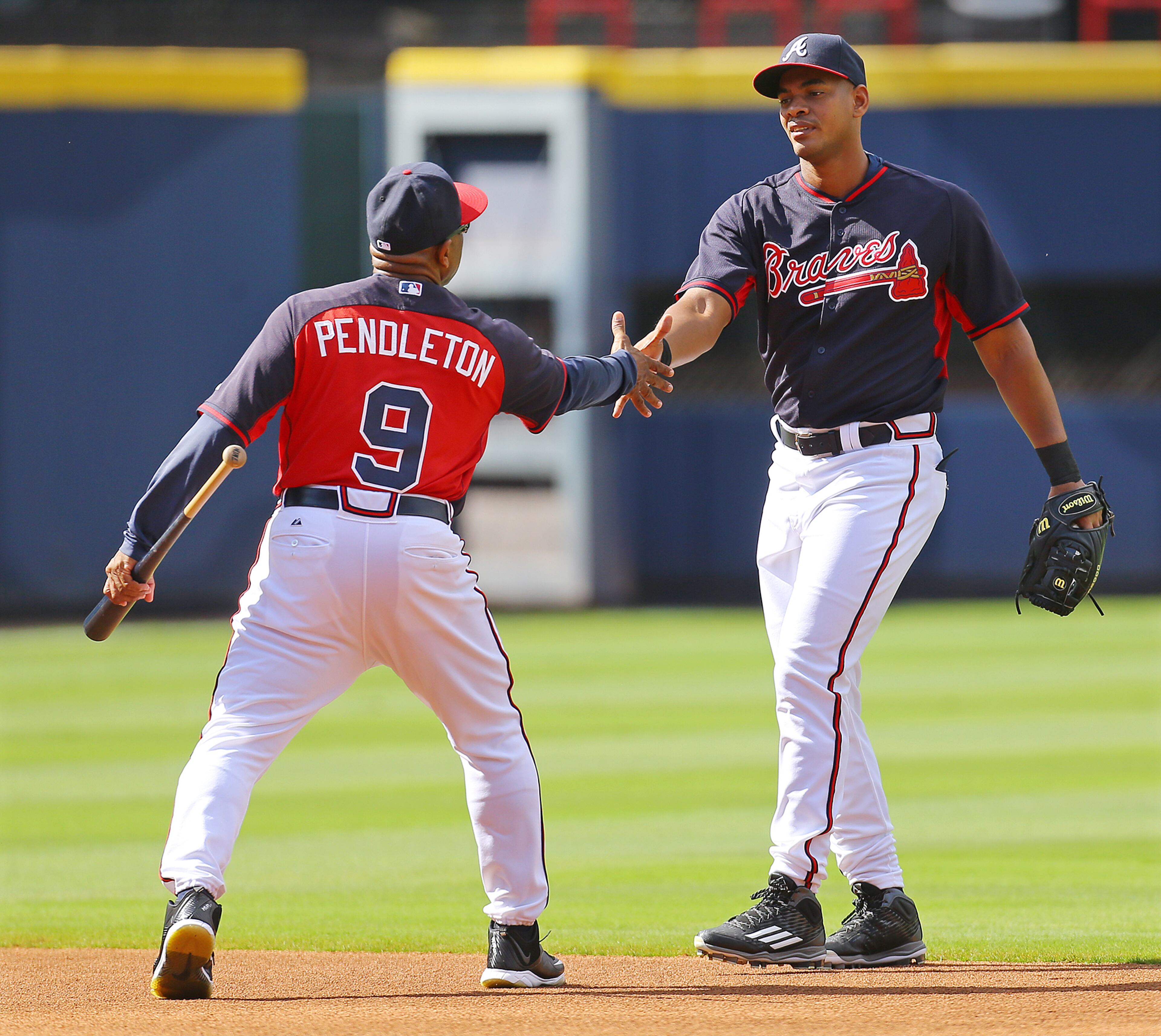 Number 15: How big is Olivera? This big -- Hector Olivera (right) dwarfs coach Terry Pendleton on Sept. 1. Photo by Curtis Compton.
