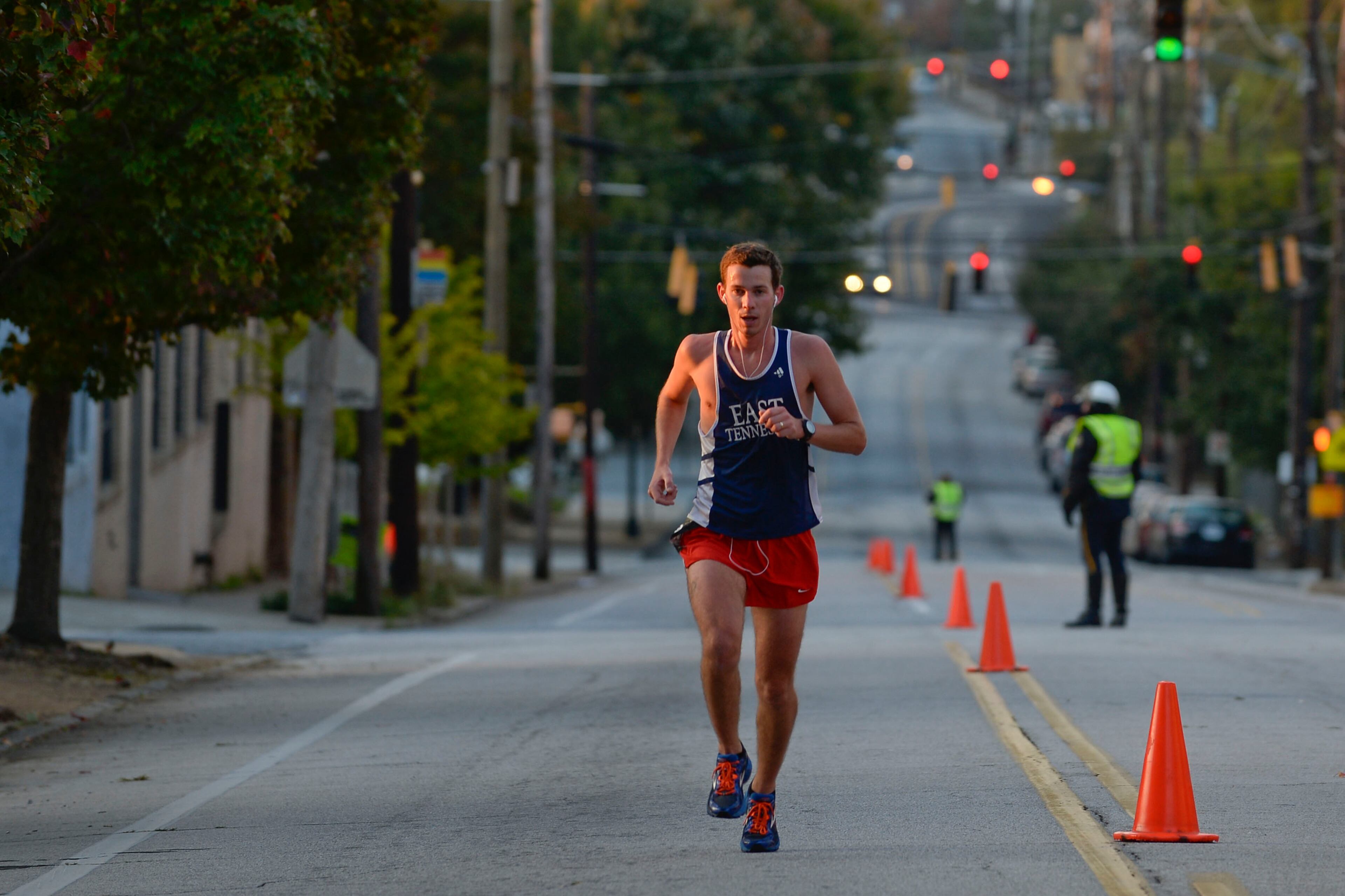 The rising sun illuminates eventual men's winner J. Penny as he runs up Jackson Street near the King Center during the 26-mile Atlanta Marathon on Sunday, Oct. 27, 2013, in Atlanta. Penny claimed victory with an unofficial time of 2:39:04. David Tulis / AJC Special