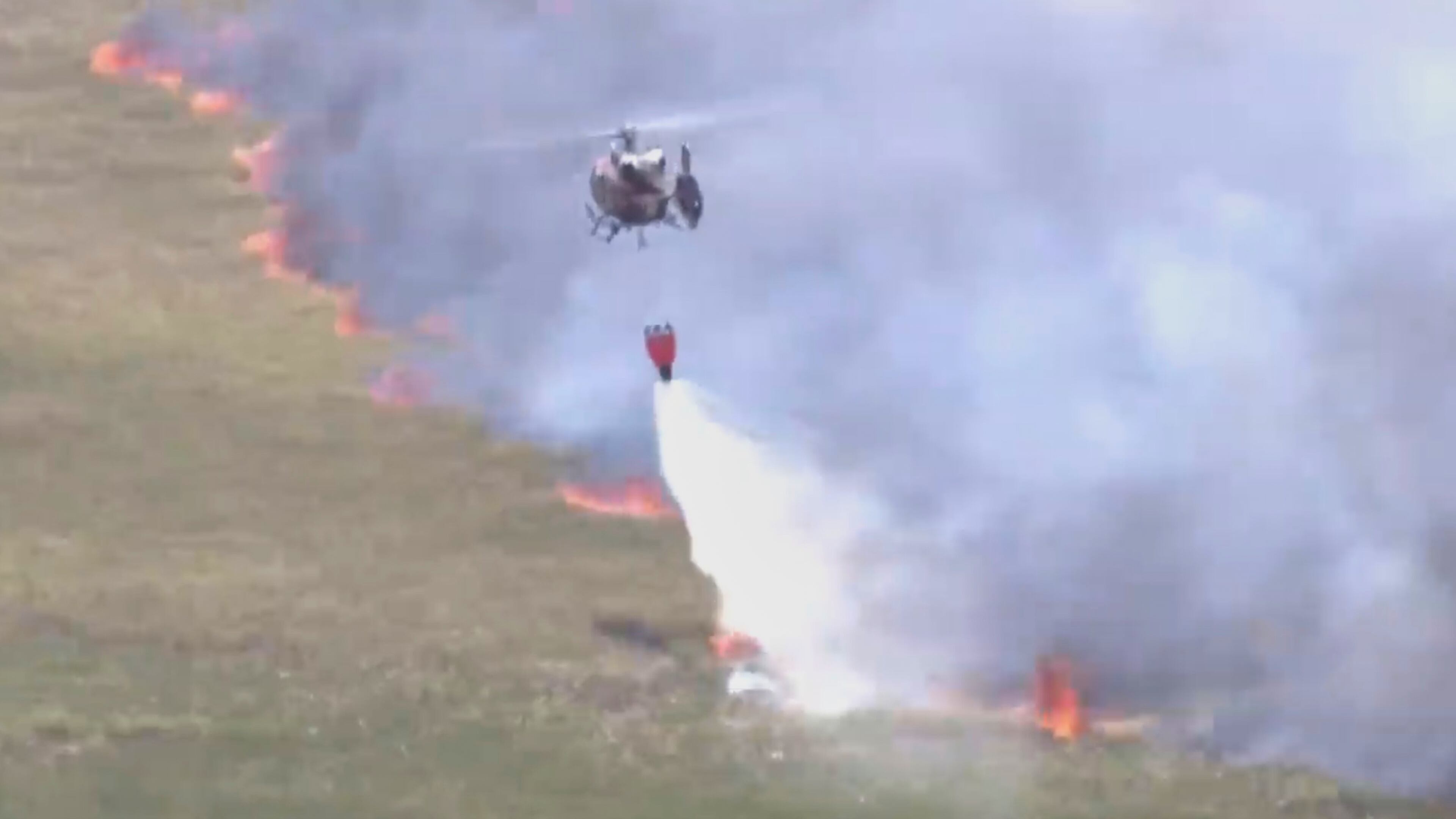 This image taken from a WSVN video shows firefighters battling a wildfire Wednesday, April 22, 2026, in Broward County, Fla. (WSVN/ABC Miami via AP)
