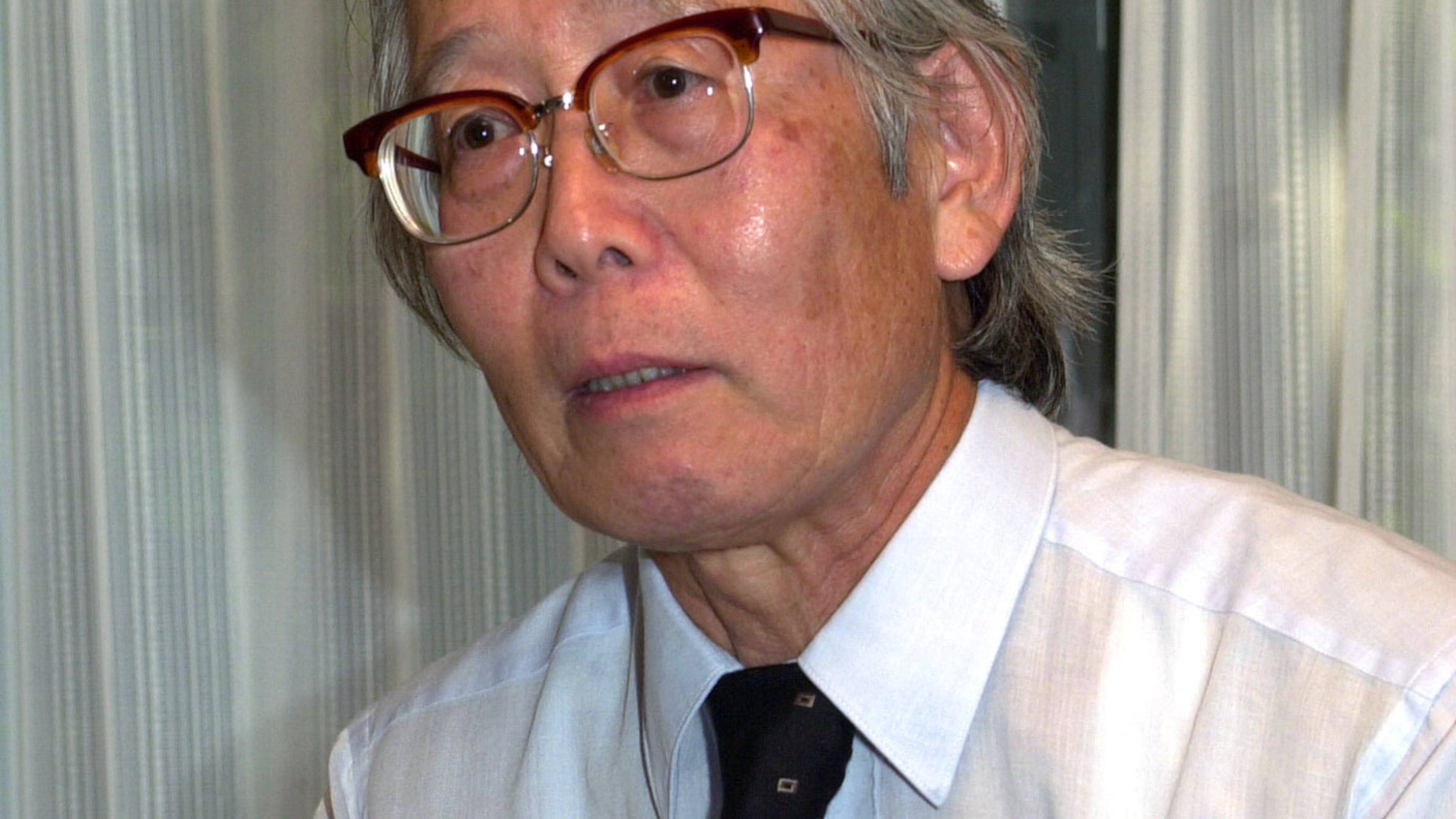 FILE - Japanese Nobel Prize winner, chemist Hideki Shirakawa, speaks with Swedish Embassy Minister Karl Leifland at his home in Yokohama, south of Tokyo, on Oct. 11, 2000. (AP Photo/Tsugufumi Matsumoto, File)