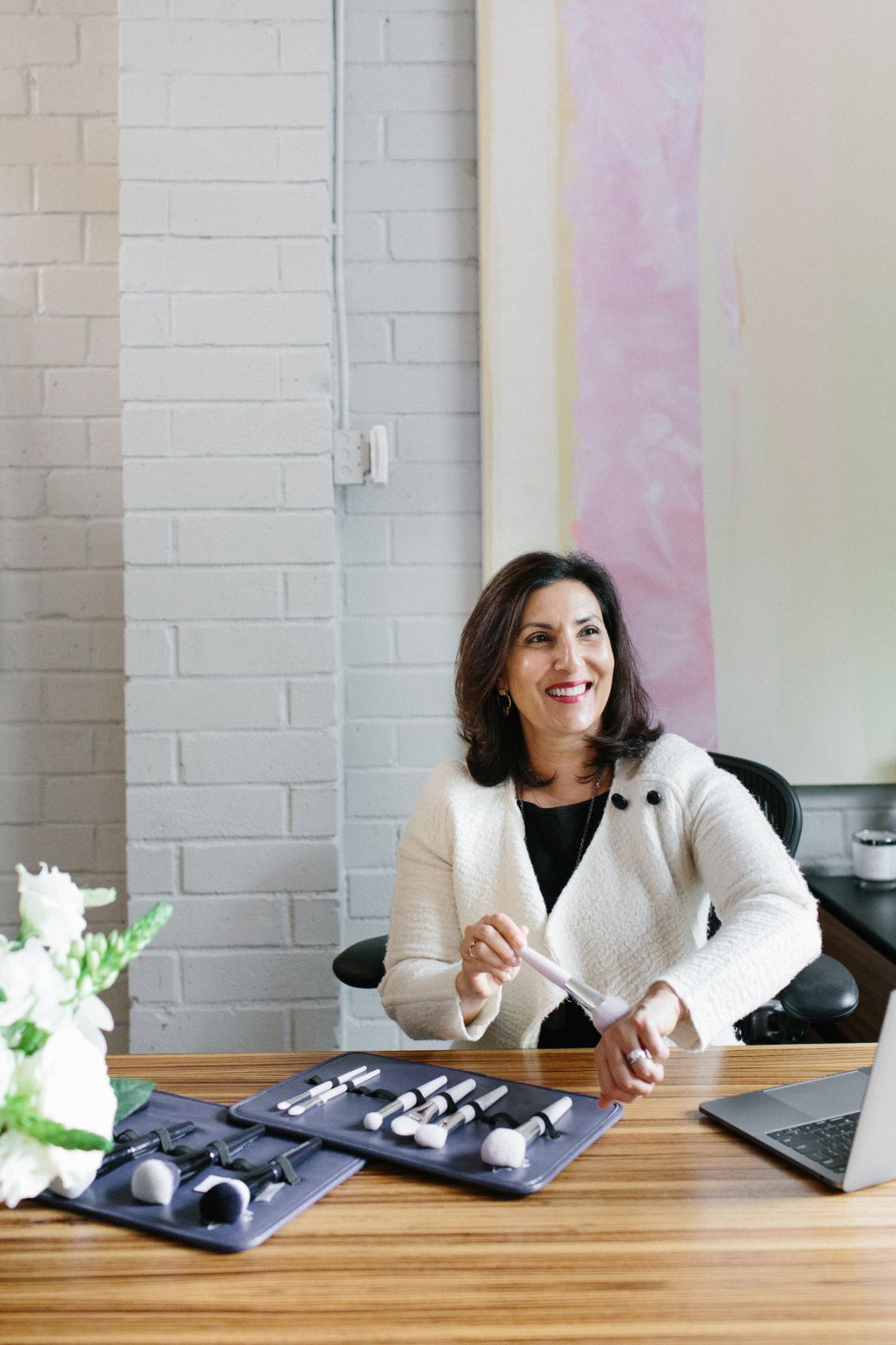 Anisa Telwar Kaicker, president and CEO of Anisa International, shows how to use her brushes. Contributed by Jennifer Young Studio