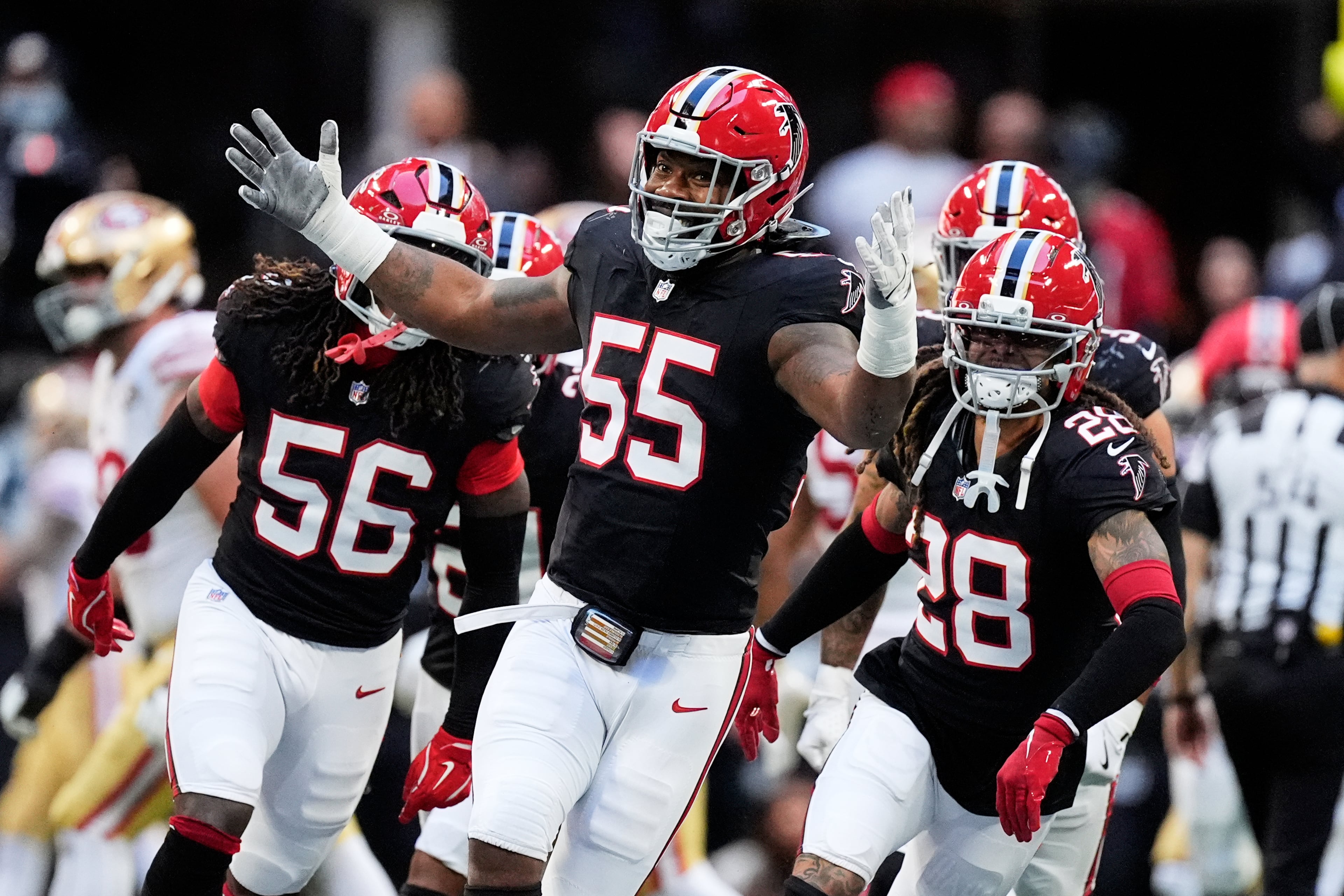 Atlanta Falcons' Za'darius Smith (55), Harold Perkins Jr. (56) and Mike Ford Jr. (28) celebrate after sacking San Francisco 49ers quarterback Brock Purdy during the second half of an NFL football game in Atlanta, Sunday, Oct. 25, 2026. (AP Photo/Mike Stewart)