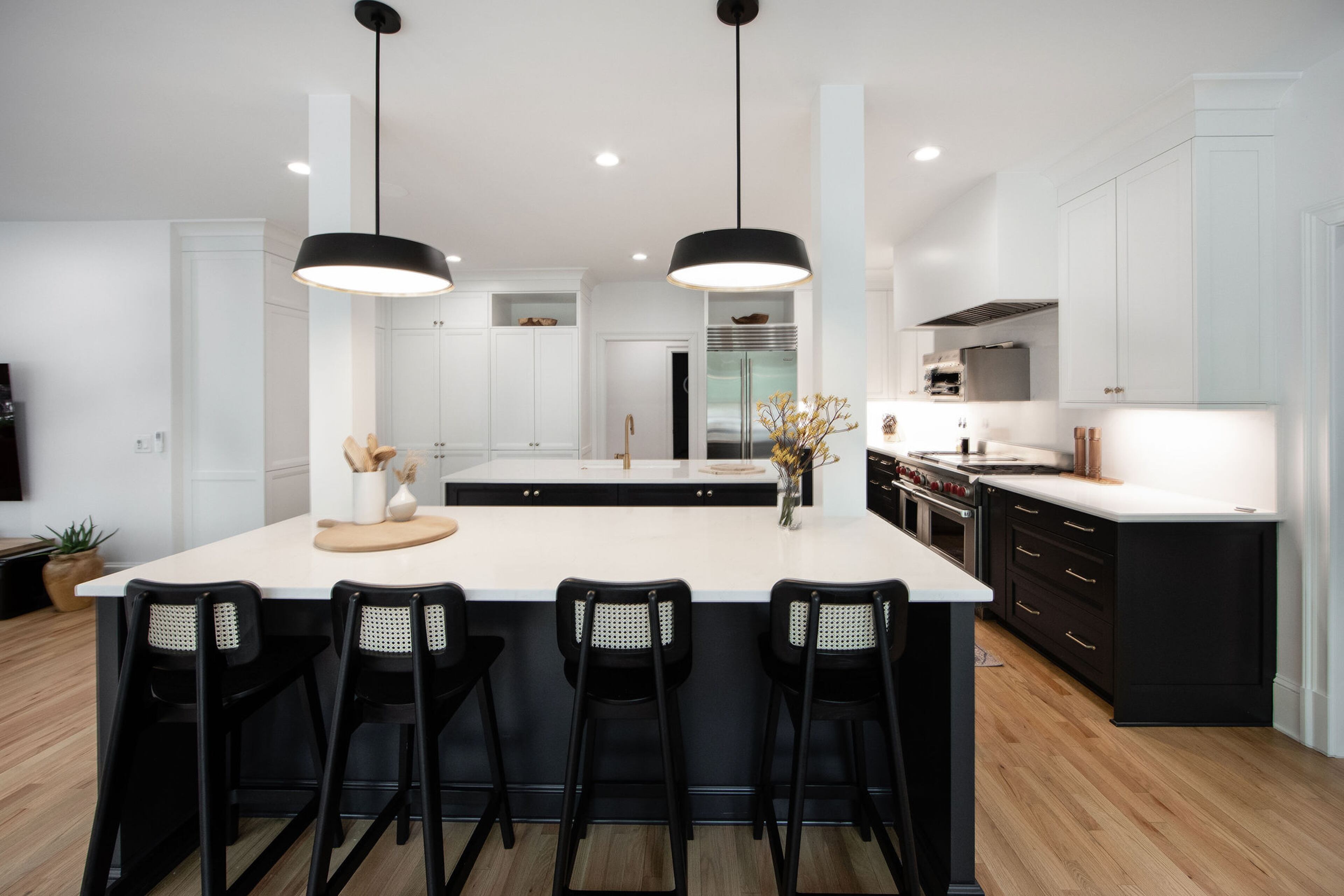 This large kitchen area used to be weighed down by dated woods and finishes, but was completely overhauled from the floors up to incorporate fresh cabinets, contrasting countertops, appliances, and hardware. Kitchen islands were also reoriented so anyone prepping food could look out to the backyard and the golf course. Josh Nelson, a self-described kitchen gadget enthusiast, says the professional-grade Salamander broiler over the stovetop is his favorite piece in the whole house. Text by Lori Keong/Photo by Amanda Winchester