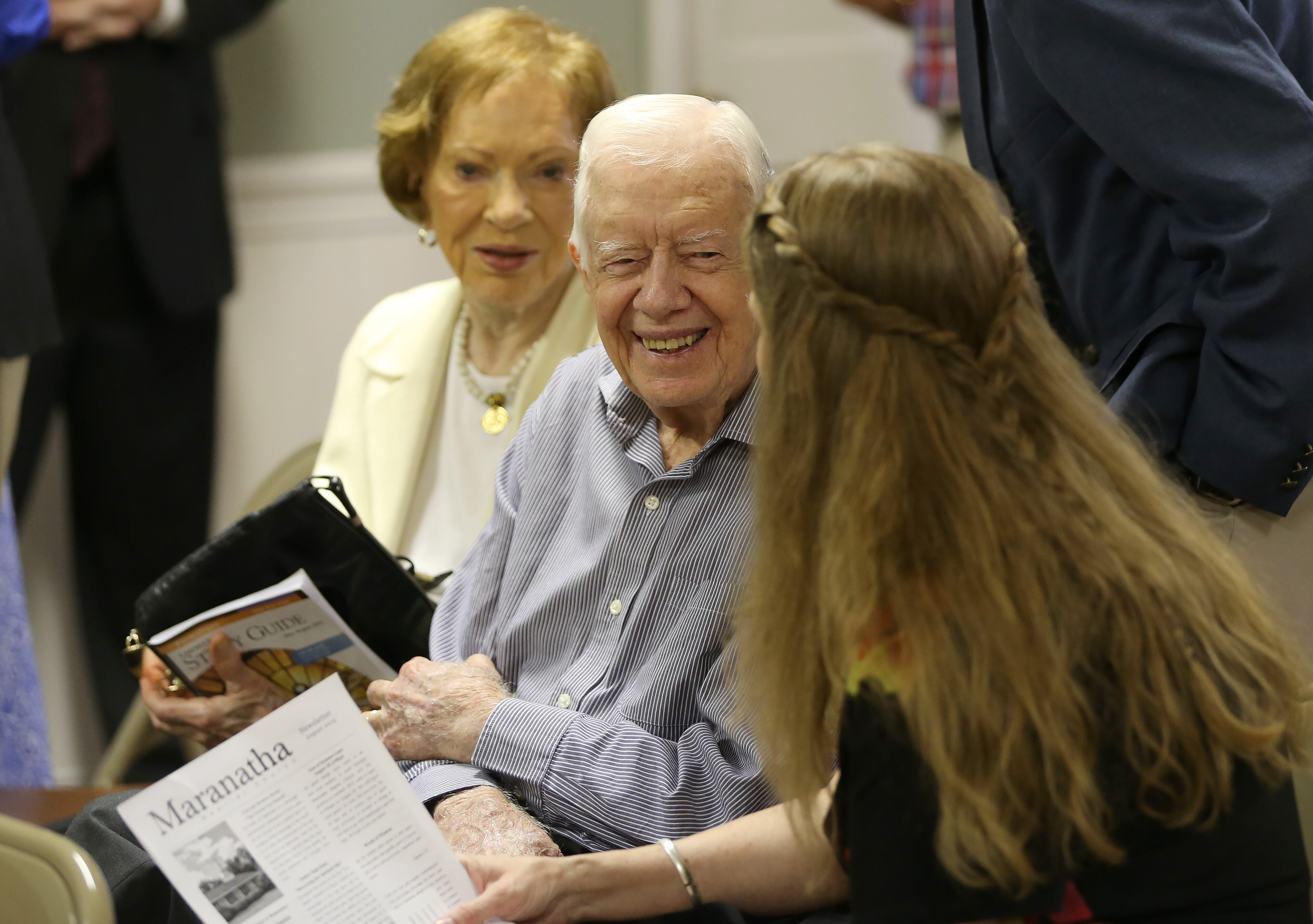 August 16, 2015 Plains: Former President Jimmy Carter talks with neighbor Stephanie Wynn before the start of bible study at Maranatha Baptist Church in Plains on Sunday morning August 16, 2015. Sunday at church was emotional because it was the first time many people had seen Carter since his announcement that he has cancer. Ben Gray / bgray@ajc.com