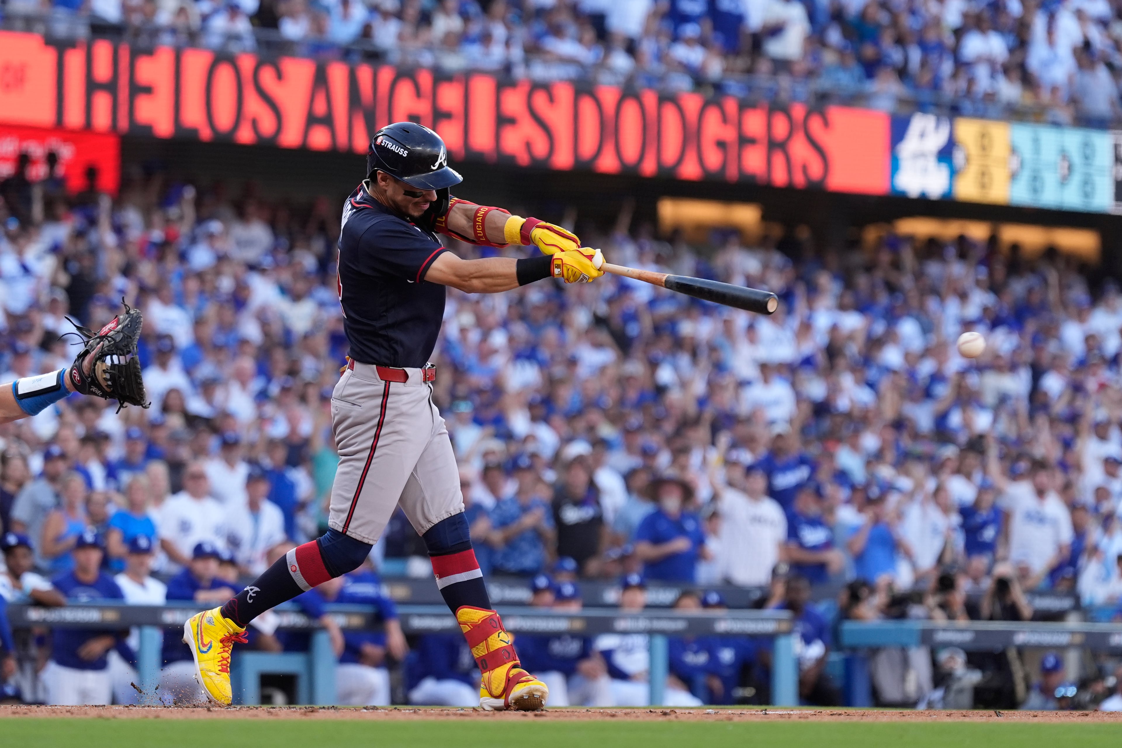 Atlanta Braves' Mauricio Dubón hits an RBI single during the first inning of Game 2 of a National League Division Series baseball game against the Los Angeles Dodgers Sunday, Oct. 4, 2026, in Los Angeles. (AP Photo/Mark J. Terrill)