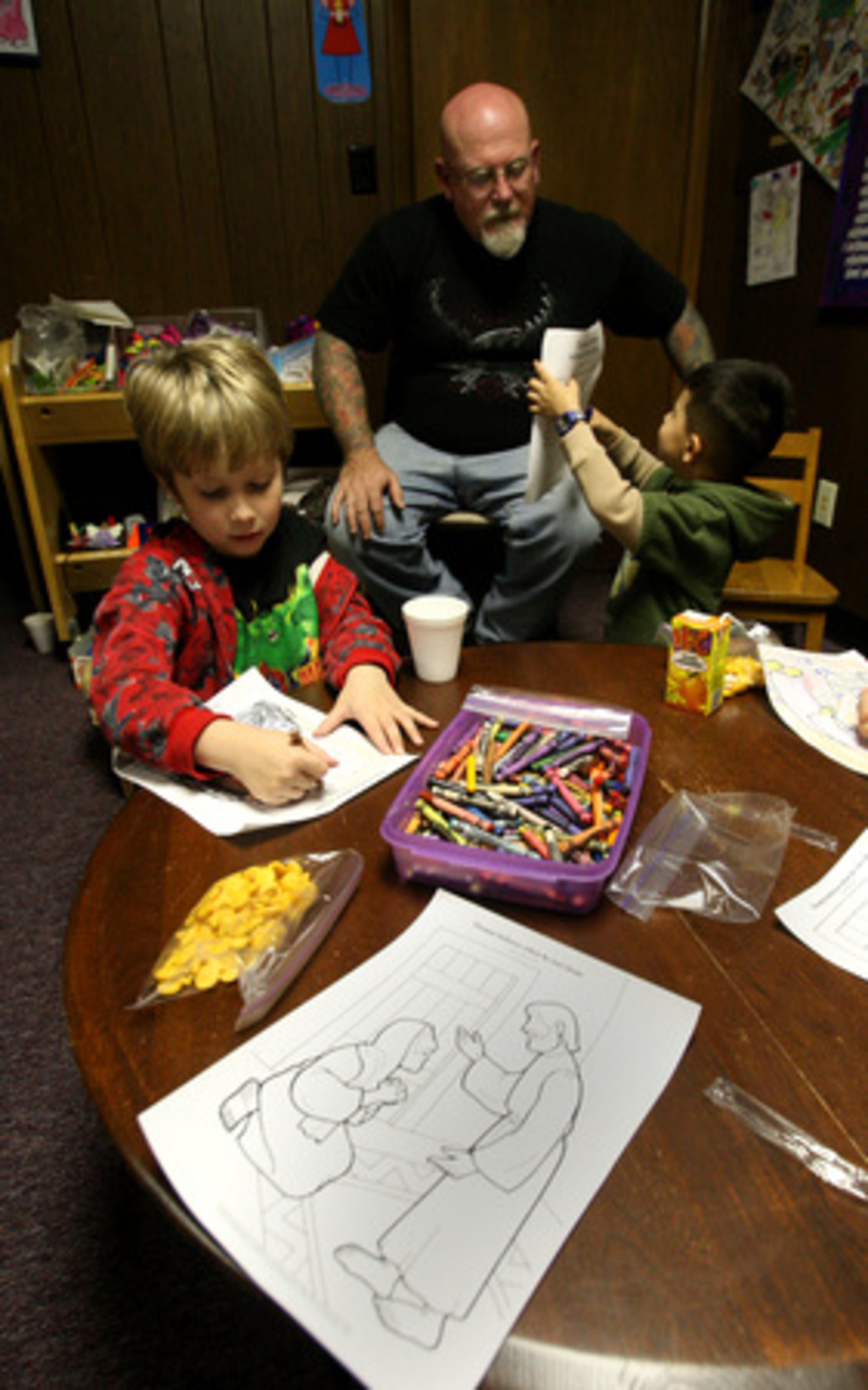 Tom Hamilton, 51, co-pastor of Sozo New Covenant Fellowship Church in Tucker listens to Ralphie Kilelee as he shows him a picture.