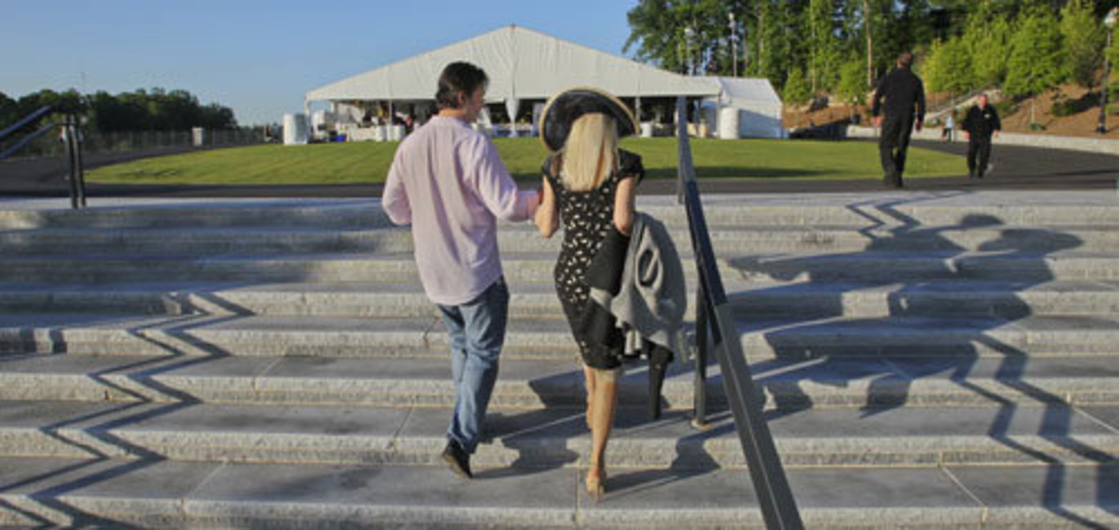 Paul Herris helps Christa Burton up the stairs toward the tent. Herris watched the Diana wedding with his mom years ago and wanted to carry on the tradition.