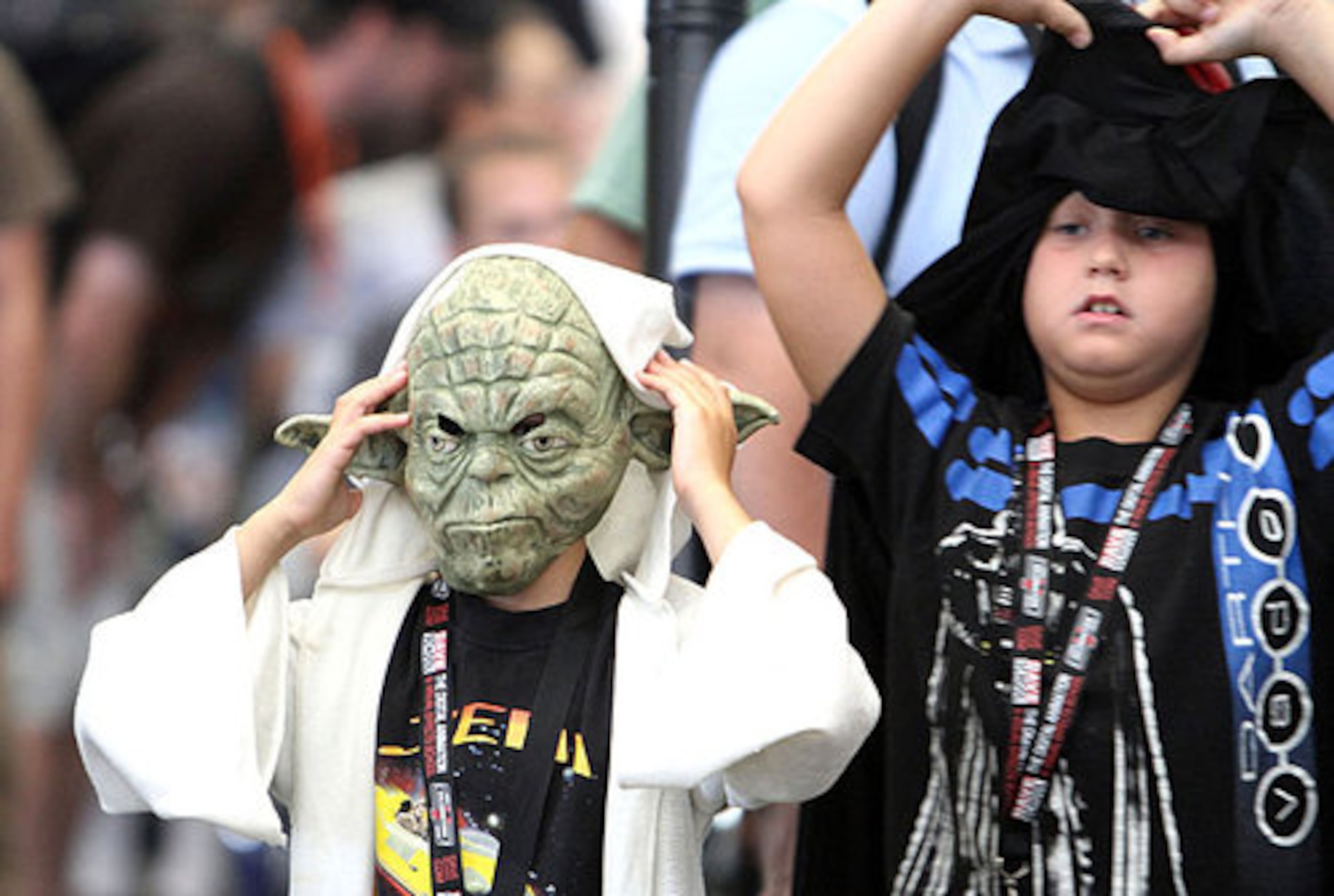 Wyatt Hoar, 7, dressed as Yoda and Kyler Hoar, 7, dressed as Darth Maul, wait in line.