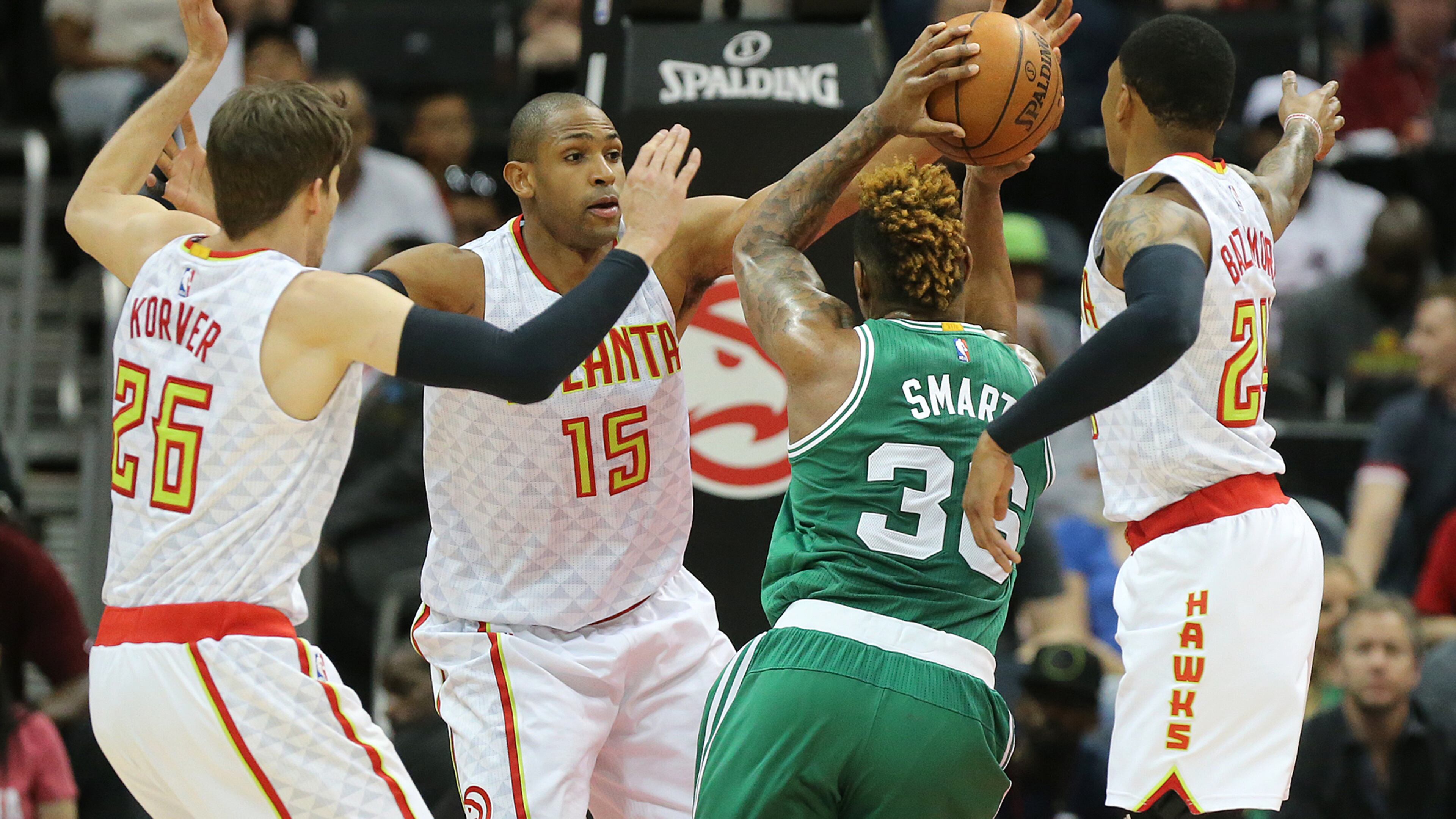 Atlanta Hawks Kyle Korver, (26) Al Horford (15) and Kent Bazemore, right, triple team Boston Celtics Marcus Smart during the first half of an NBA playoff basketball game Tuesday, April 19, 2016, in Atlanta. ( Curtis Compton/Atlanta Journal-Constitution via AP) MARIETTA DAILY OUT; GWINNETT DAILY POST OUT; LOCAL TELEVISION OUT; WXIA-TV OUT; WGCL-TV OUT; MANDATORY CREDIT