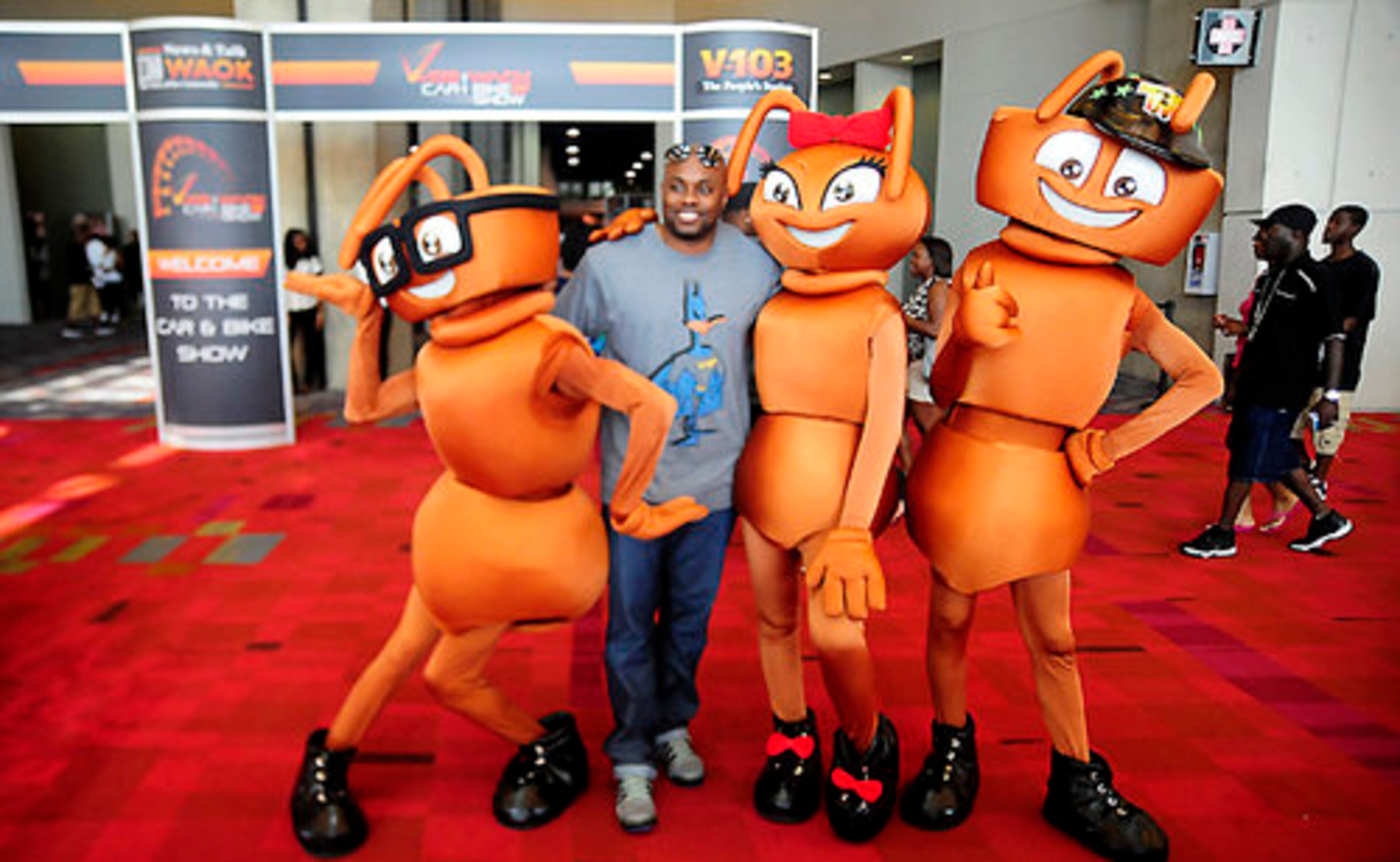 Charles Johnson poses for a photo with ants Max, Sofi and Riley from the show "Ant Hill Live" during V103's Car & Bike show at the Georgia World Congress Center.