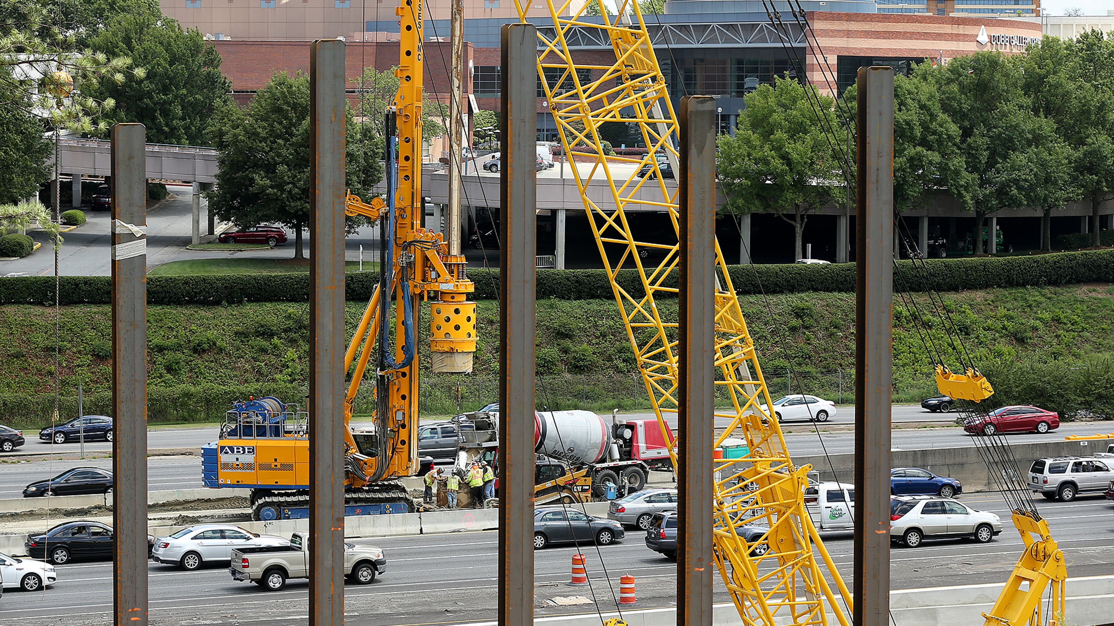 A crew works in the middle of I-285 in October 2016 where Cobb County started construction on a multi-use bridge over I-285 in the Cumberland Area across from the Cobb Galleria.