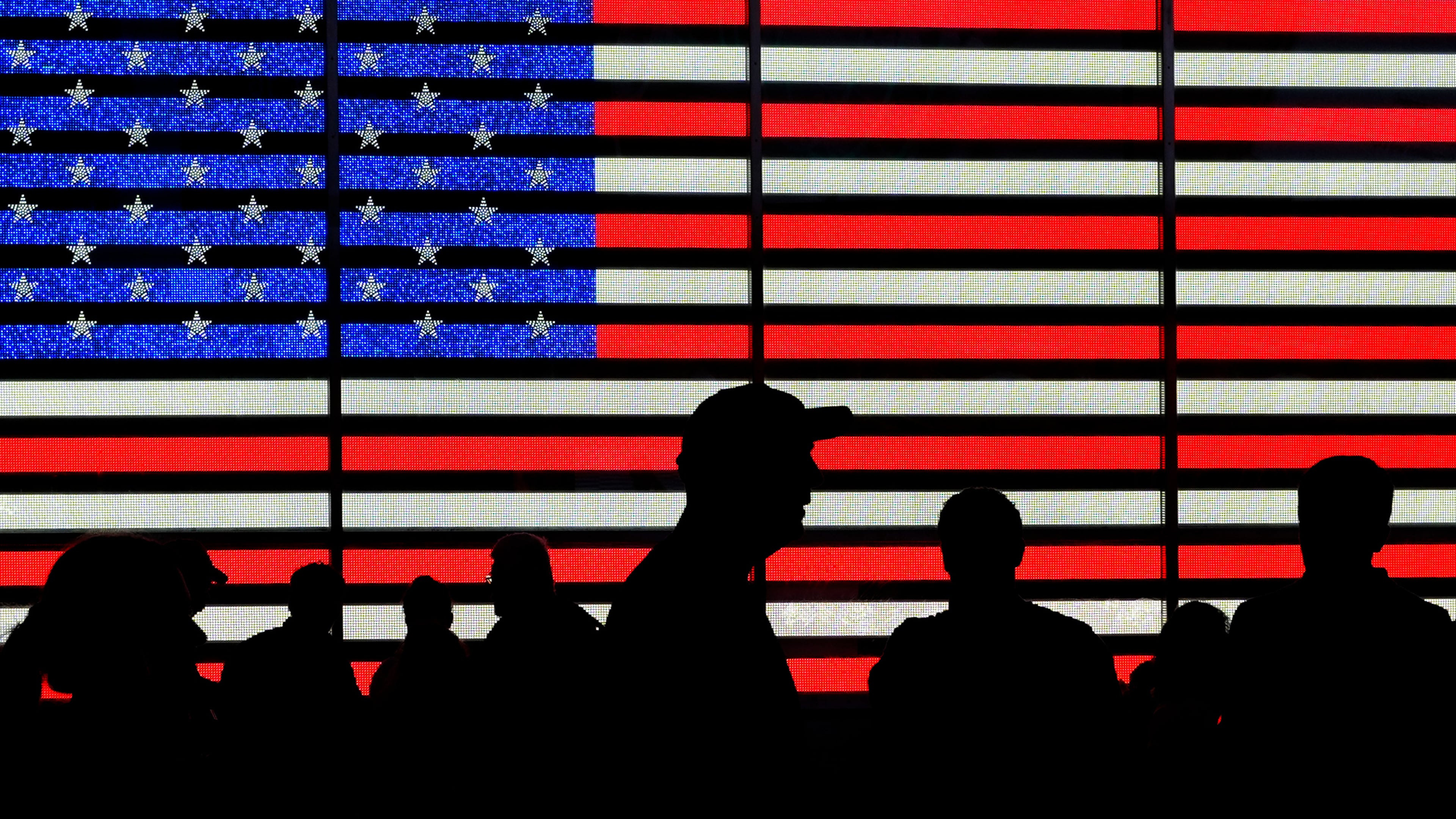 FILE - People stand in Times Square in New York, Aug. 9, 2024. (AP Photo/Pamela Smith, File)