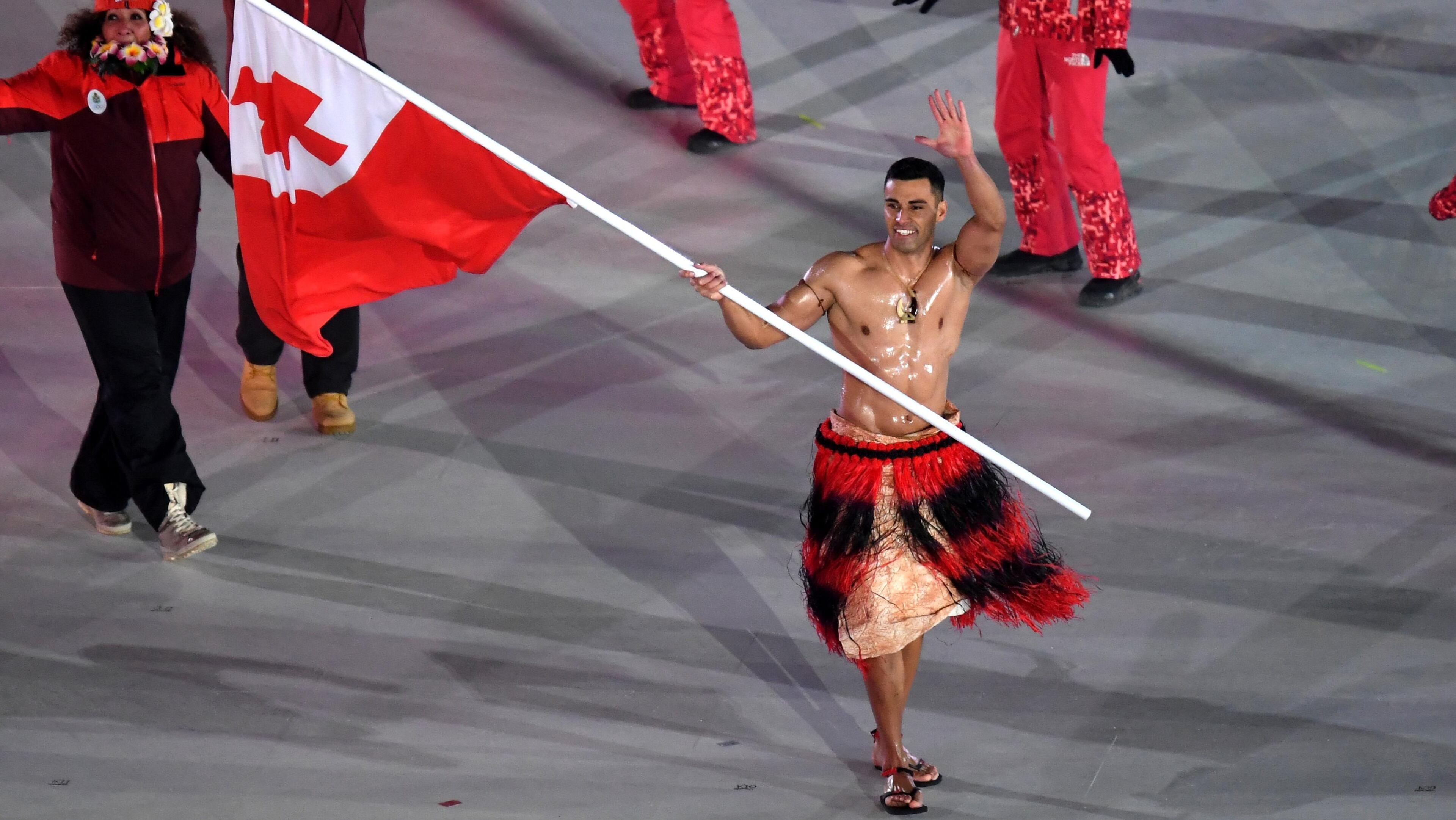 PYEONGCHANG-GUN, SOUTH KOREA - FEBRUARY 09: Flag bearer Pita Taufatofua of Tonga and teammates enter the stadium during the Opening Ceremony of the PyeongChang 2018 Winter Olympic Games at PyeongChang Olympic Stadium on February 9, 2018 in Pyeongchang-gun, South Korea. (Photo by Pool - Frank Fife/Getty Images)