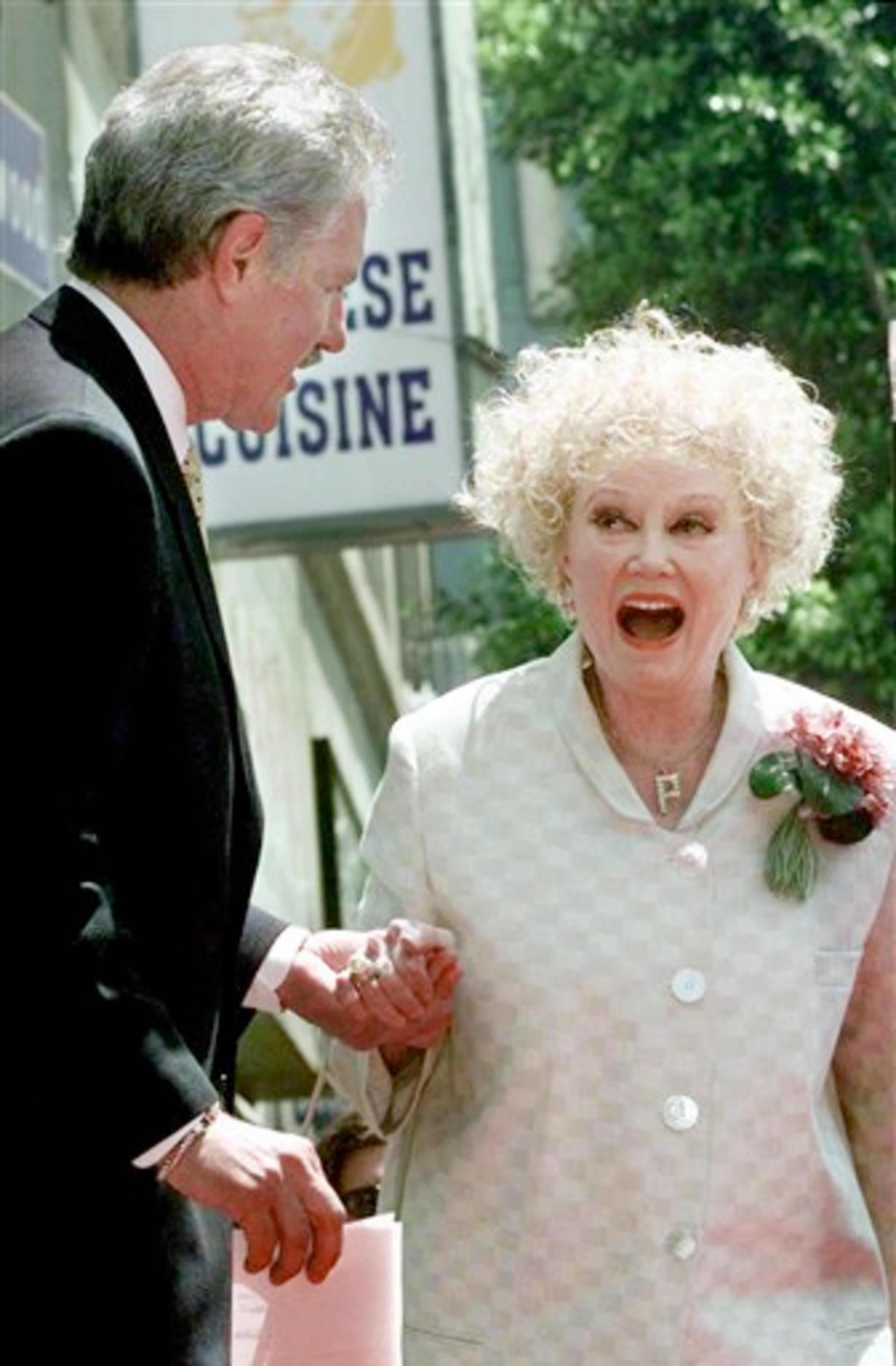 FILE-In this May 17, 1999 file photo, Emmy award winning game show host, Alex Trebek greets actress and comedian Phyllis Diller before receiving his newly-dedicated star on the Hollywood Walk of Fame in the Hollywood section of Los Angeles. Diller, the housewife turned humorist who aimed some of her sharpest barbs at herself, died Monday, Aug. 20, 2012, at age 95 in Los Angeles. (AP Photo/Nick Ut, File)