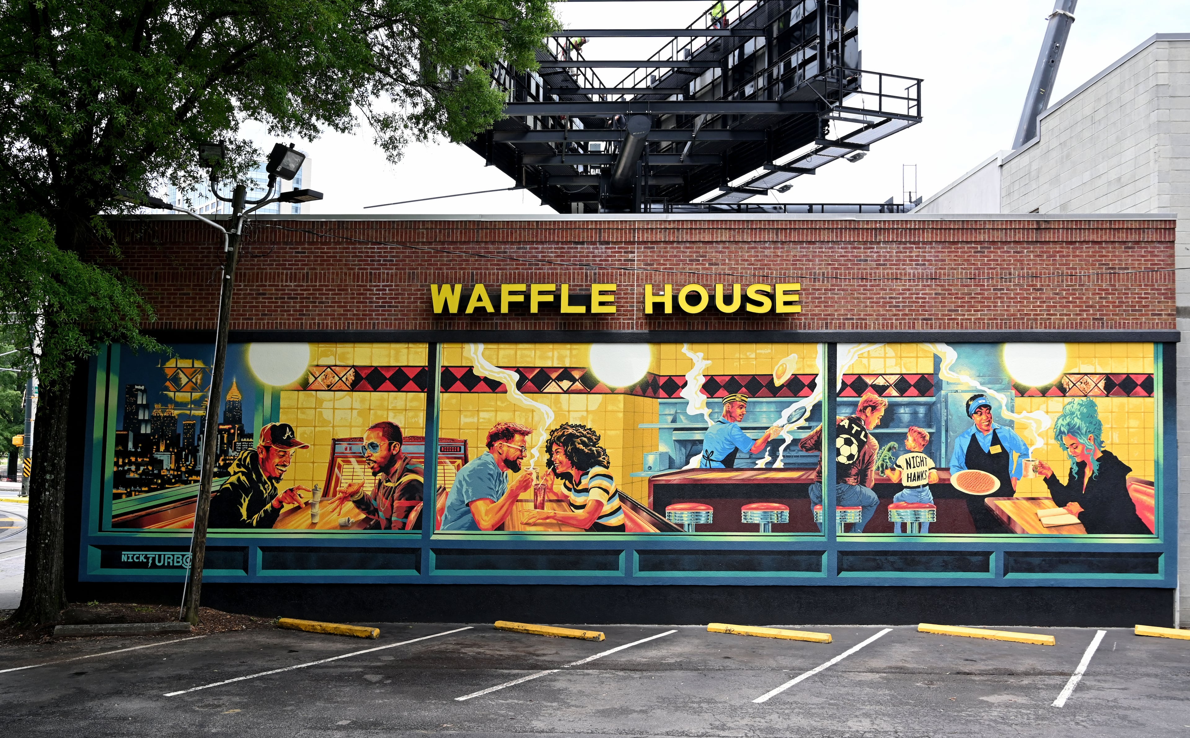 Artist Nick Benson was commissioned to create this mural on a downtown Atlanta Waffle House as an Atlanta homage to Edward Hopper’s Nighthawks painting. (Hyosub Shin/AJC)