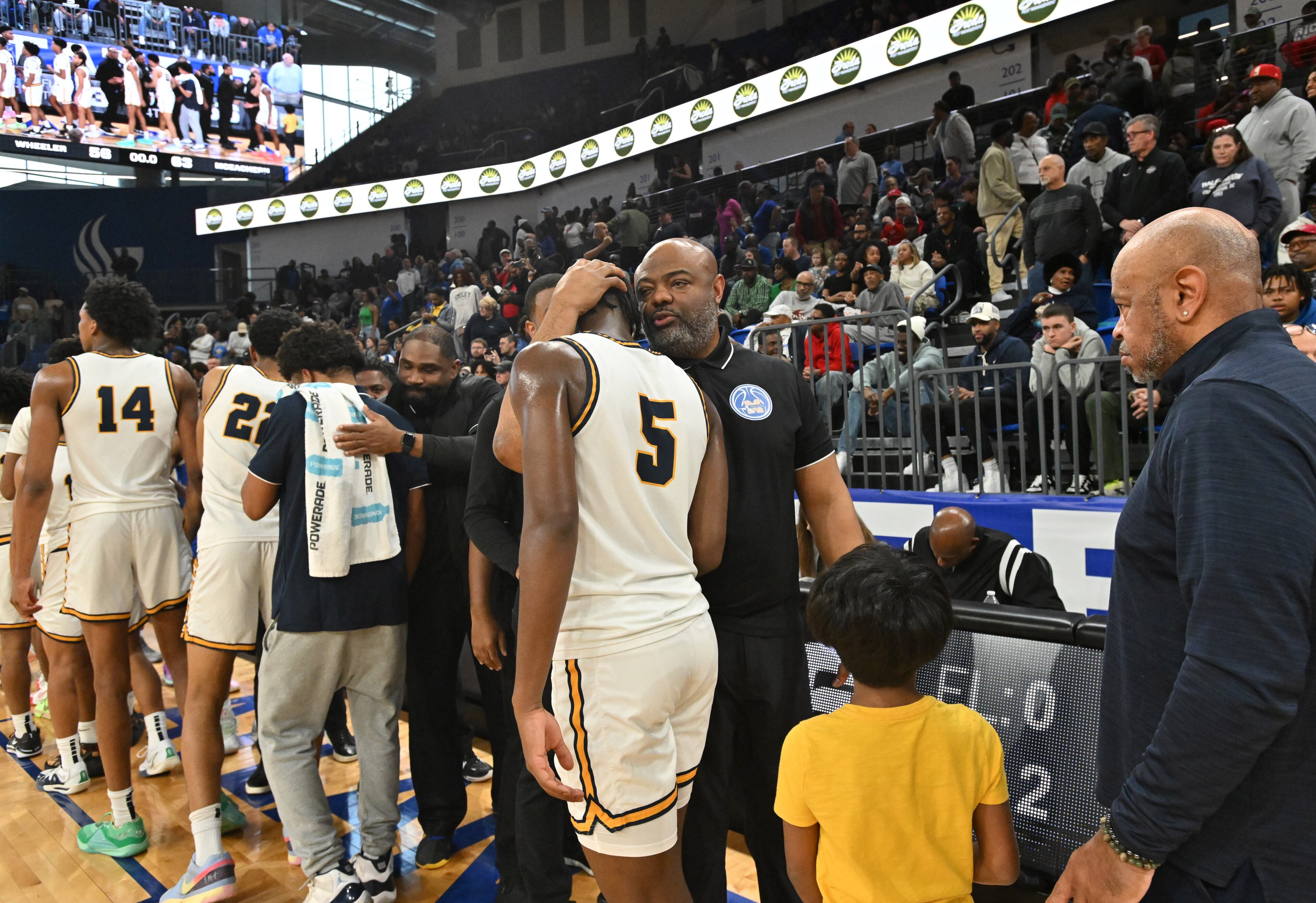 McEachern's head coach Tremayne Anchrum comforts Wheeler's Ricky Mckenzie (5) during GHSA Class 7A Semifinal basketball game at GSU’s Convocation Center, Saturday, Mar. 2, 2024, in Atlanta. (Hyosub Shin / Hyosub.Shin@ajc.com)