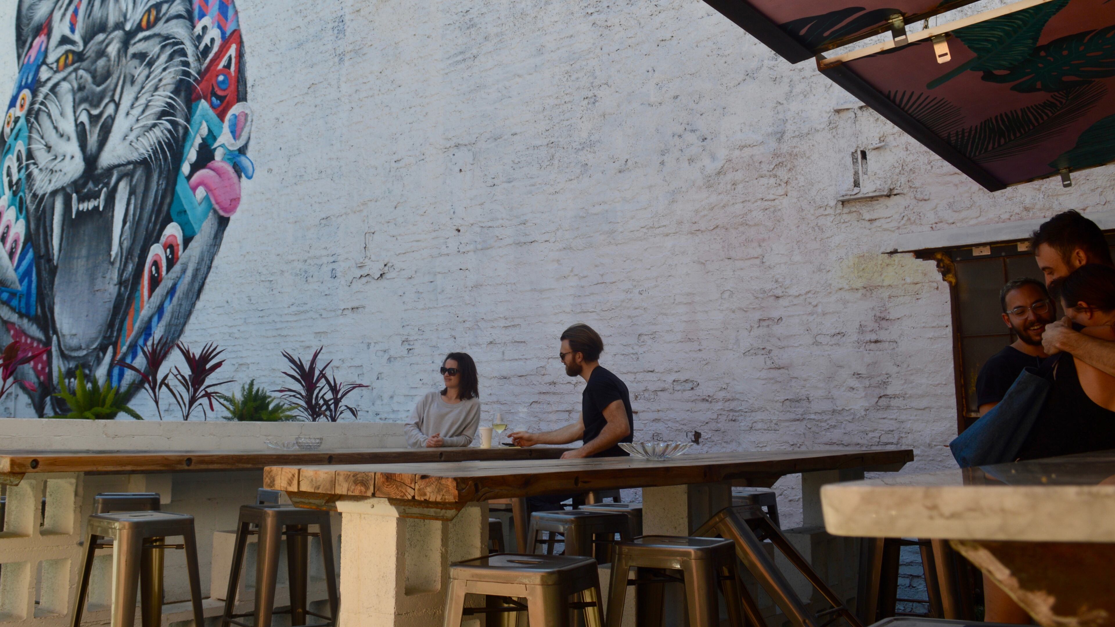 The patio at 8ARM includes long communal tables that look over Ponce de Leon Ave.