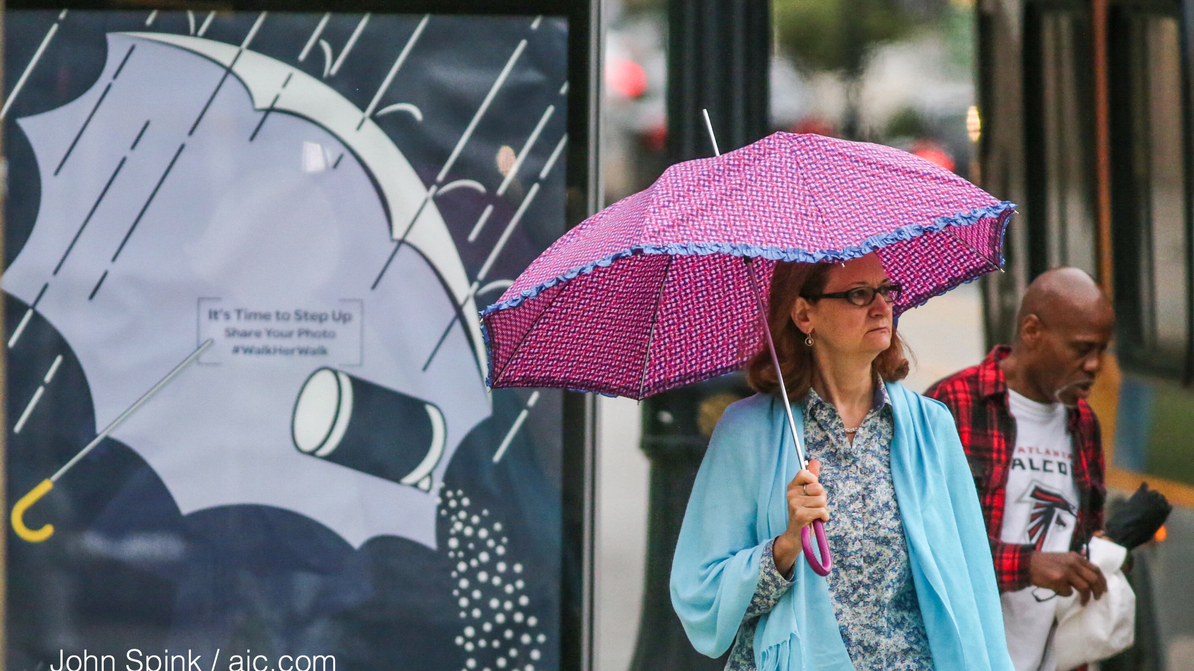 Anne Melfi passes the Morton Salt advertisement on a MARTA bus stop at 17th and Peachtree streets in Midtown. JOHN SPINK / JSPINK@AJC.COM