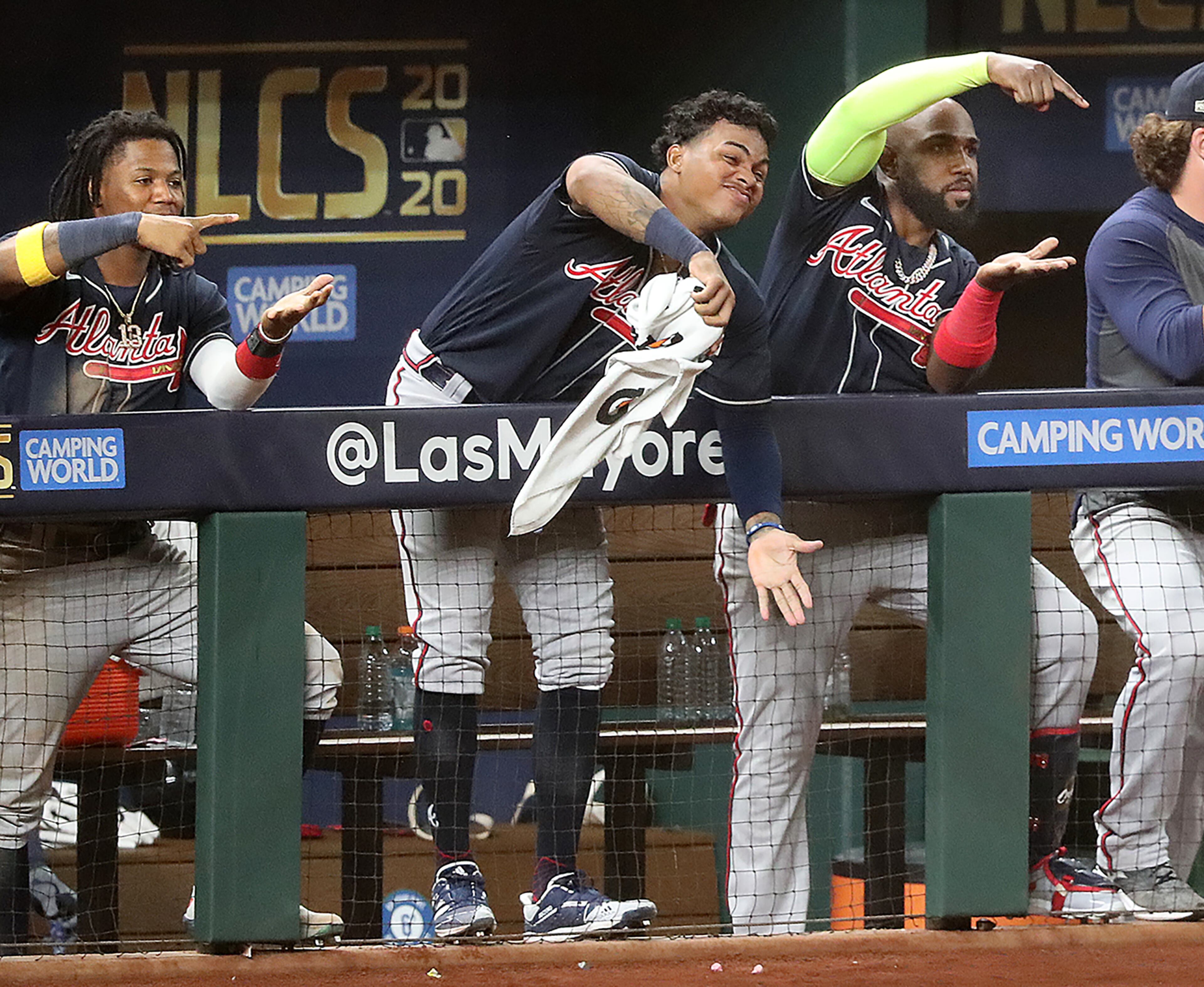 Braves (from left) Ronald Acuna, Cristian Pache, and Marcell Ozuna mix it up from the dugout in reaction to Ozzie Albies' solo homer in the 8th inning. “Curtis Compton / Curtis.Compton@ajc.com”